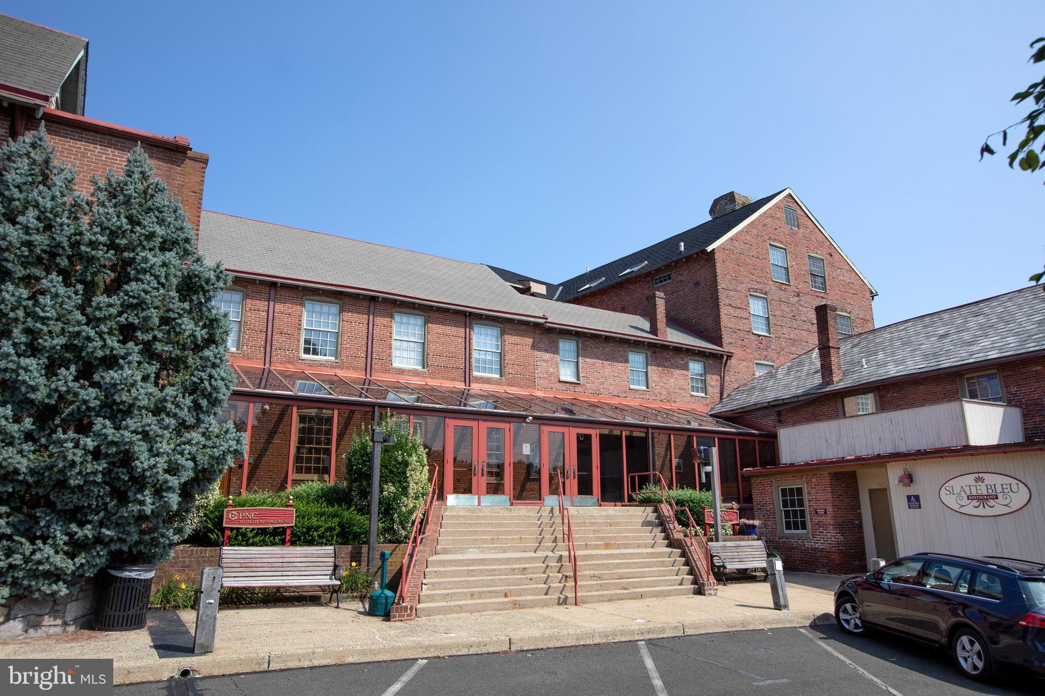 Second floor, elevator serviced office space in the historic Ag Works building, this suite features 5 private offices and a large conference room, high ceilings with exposed antique beams, and in-suite powder room and kitchenette plus multiple storage rooms. Plenty of parking in more than one lot, close to the center of town without giving up on space, immediately adjacent to the SEPTA R-5 train station and regional bus stations.