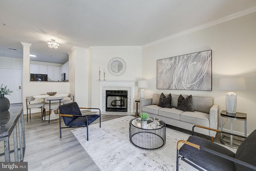 3/30 Open House has been Canceled... Updated Condo Located Across the Street from the Dunn Loring Metro stop!  Luxury Vinyl Plank Flooring, Brand New Paint, and Updated Light Fixtures.  Open Concept Kitchen with Granite Countertops, 42" Cabinets, and Gas Cooking.  Gas Fireplace with Marble Surround in the Living Room.  9 Foot Ceilings with Crown Molding.  Large Primary Bedroom with 2 Closets and En-suite Bathroom.  The Primary Bathroom has a Soaking Tub and Separate Shower.  New Wall and Door added for the Second Bedroom.  Washer and Dryer in the Unit.  Coat Closet by the front door.  Assigned Garage Parking Space and Separate Storage Unit included.  There is a Community Club House with a Fitness Center, Wading Pool and Party Room.  Stroll to the Dunn Loring Metro, Harris Teeter, Starbucks, Dining and Retail located across the street or to the nearby popular Mosaic District which is less than a mile away.  Also Close to Tysons Corner Retail and Restaurants.  Easy access to 495, 66 and 50.