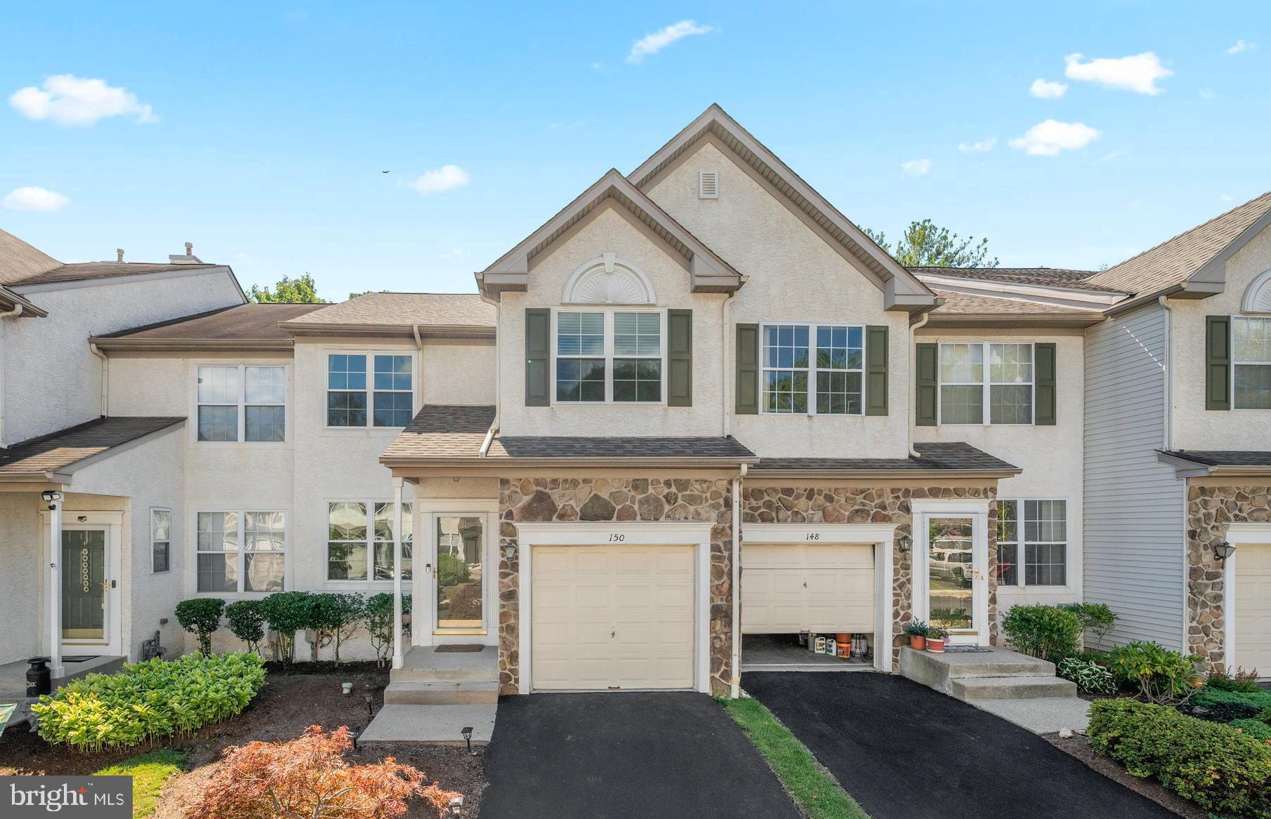 Welcome to 150 Mountain View Drive, a move-in ready 3-bedroom, 2.5-bath townhome in the highly desirable Valley View community of West Chester. Perfectly situated within walking distance to Exton Station and just minutes from major routes including US-30, 202, and Pottstown Pike, the location is unmatched! A quick 5-10 minute drive brings you to all the shops, restaurants, and conveniences of Exton – whether it’s Main Street, the Shops at Exton, Exton Square Mall, or Whiteland Town Center, everything you need is close by. Inside, you’re welcomed by an open-concept living and dining area that provides the perfect space for gathering with family and friends. The sunny kitchen and family room combination is equally inviting. The kitchen features granite countertops, abundant wood cabinetry, a center island with seating, and a large pantry for storage. It’s also outfitted with brand-new range, dishwasher, and microwave, plus a stainless-steel refrigerator. The adjoining family room is brightened by natural light from two rear-facing windows and is warmed by a gas fireplace. Sliding doors near the kitchen lead out to a spacious rear deck – ideal for seamless indoor/outdoor dining and entertaining. Completing the first floor are a convenient half bath, large coat closet, and access to the attached one-car garage. Upstairs, you’ll find three generously sized bedrooms. Two front-facing bedrooms feature premium wood blinds, large closets, and easy access to a full hall bath with shower/tub combo. The expansive primary suite overlooks the backyard and includes a walk-in closet and a luxurious ensuite bath with double sinks, jetted tub, and separate shower. A large second-floor laundry room, with new washer and dryer, makes day-to-day living even more convenient. The lower level adds nearly 600 square feet of finished space, perfect for a recreation room, home office, or gym, and the large unfinished space offers plenty of storage. Hardwood floors throughout both the first and second floors elevate the home’s style, while practical updates such as a newer roof (2020) and HVAC system (2019) provide peace of mind. The community itself offers sidewalks and a nearby park, creating an inviting environment to enjoy walks, playtime, or simply connecting with neighbors. With its prime location, thoughtful layout, recent upgrades, and community amenities, 150 Mountain View Drive is the perfect blend of comfort, convenience, and lifestyle.