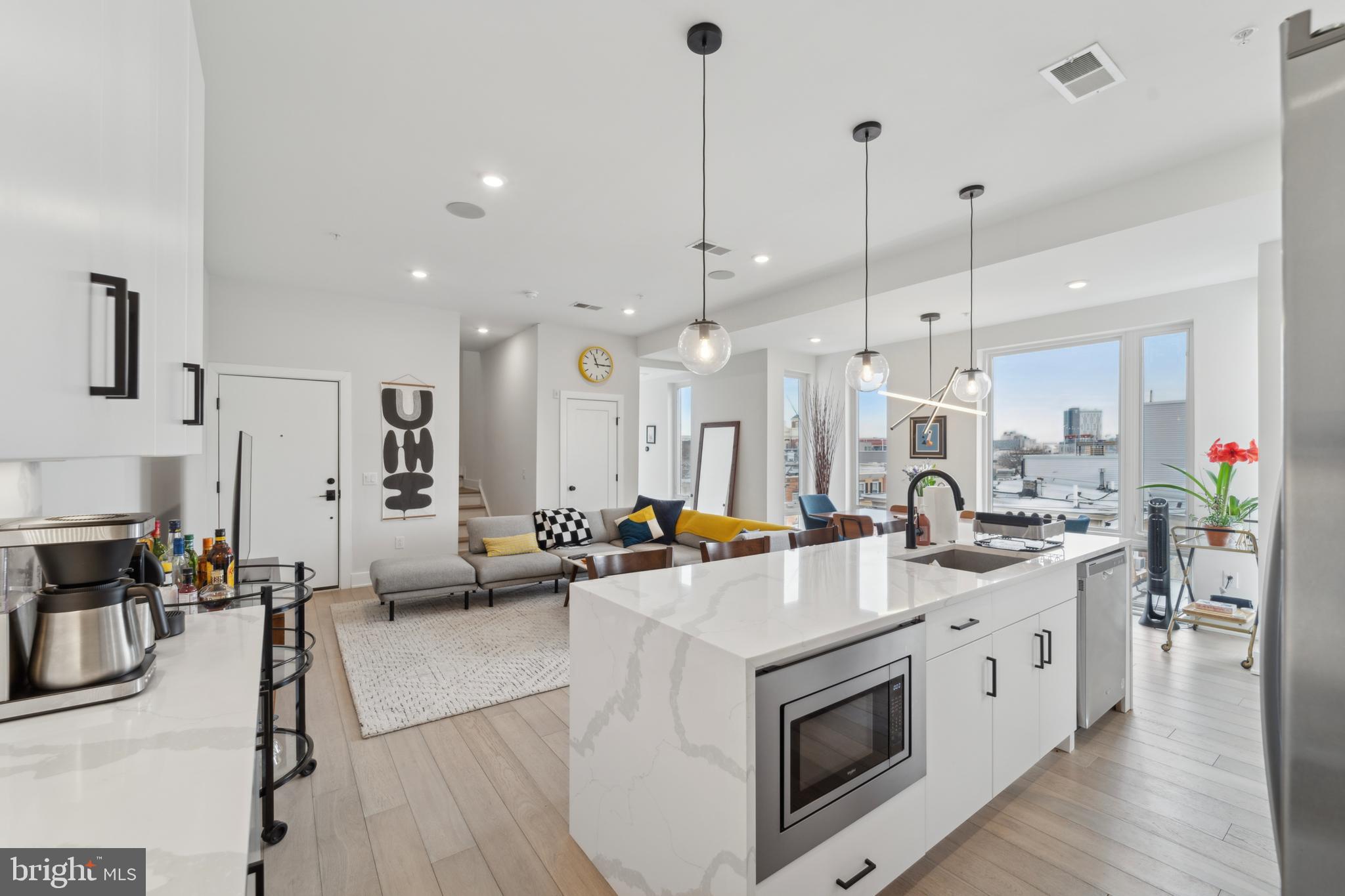 Located in the heart of Francisville, this stunning 2 bedroom, 2 bathroom luxury condo offers roughly 1,600 sq ft of contemporary living space with high-end finishes, 1 car private parking and an unbeatable private rooftop deck with breathtaking Center City skyline views. The open concept design is flooded with natural light from oversized windows, highlighting the wide plank hardwood floors and sophisticated details throughout. The gourmet eat-in kitchen boasts a quartz waterfall island, custom cabinetry, stainless steel appliances, gas range, and stylish pendant lighting, seamlessly flowing into the spacious living and dining areas, perfect for entertaining. The primary suite is a true retreat, featuring a custom walk in closet and a spa like en-suite bathroom with a double vanity, oversized glass enclosed rainfall shower, and sleek matte black fixtures. The second bedroom is equally bright and versatile, ideal for guests or a home office. Both bathrooms are elegantly designed with modern finishes and ample storage. A true highlight of this home is the massive private rooftop oasis, which spans the entire footprint of the building—offering an additional 1,600 sq. ft. of outdoor living space. This unparalleled rooftop deck is perfect for relaxing, entertaining, or hosting unforgettable gatherings, complete with a dry bar and panoramic city views. Additional conveniences include in-unit laundry and 1 car private parking attached to the building. With 7 years remaining on the tax abatement, this 3 year old home is a rare find in a prime location, just steps from Fairmount Ave, coffee shops, top restaurants and public transportation. Do not miss this opportunity to own a stunning, move in ready home in one of Philadelphia’s most sought after neighborhoods!