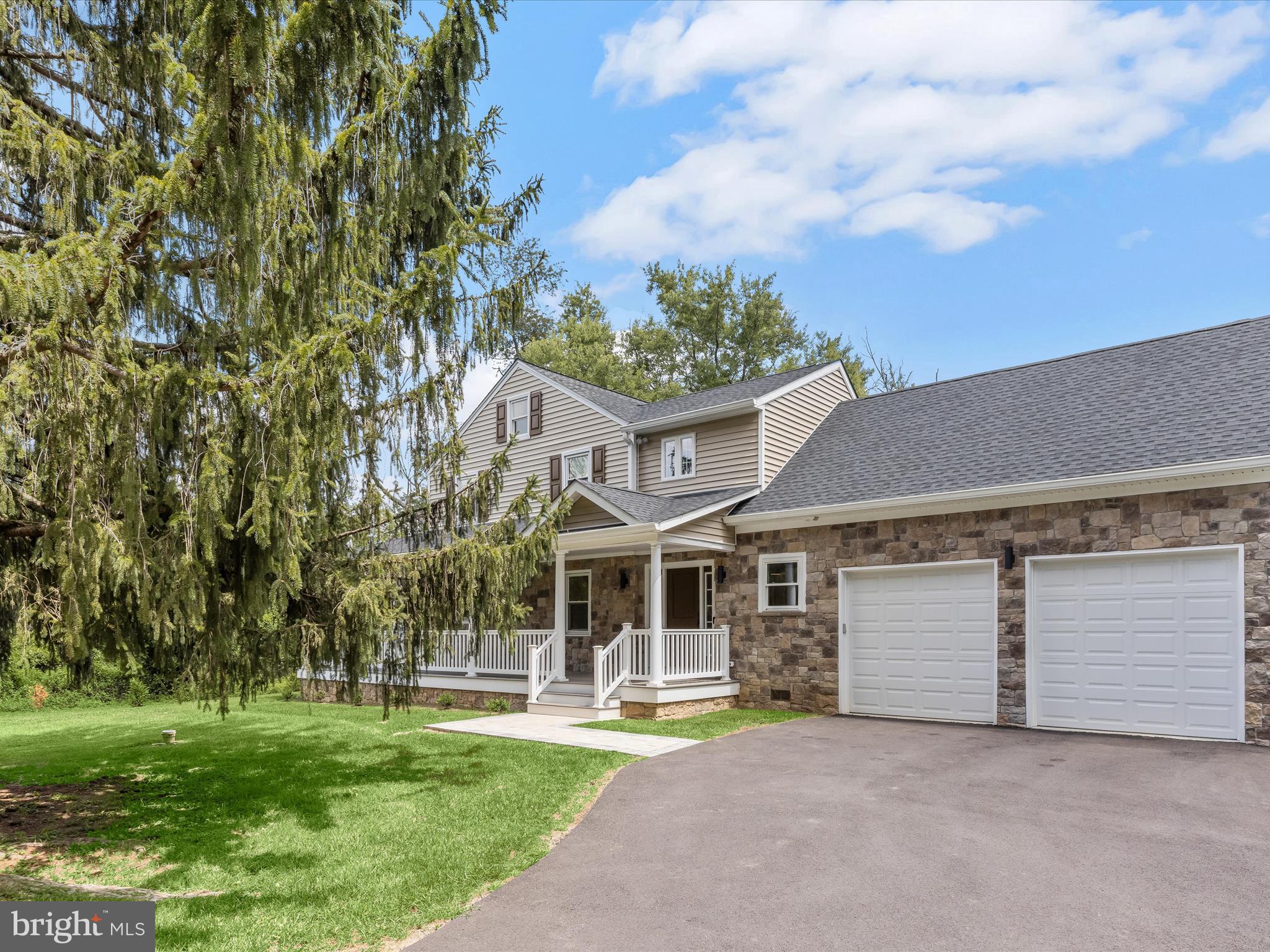 Introducing this beautifully reimagined three bedroom, three bathroom home, tucked away on a serene 0.56-acre lot, embraced by a wooded conservation area where no future development will disturb the natural surroundings. This peaceful retreat offers a blend of privacy and convenience, with Owings Mills just minutes away. A welcoming wraparound front porch sets a relaxed tone as you arrive, inviting quiet mornings and evenings spent outdoors. Inside, a gracious foyer opens to the back porch through double glass doors, framing scenic views that define the home’s tranquil character. Hardwood and Florida Tile flooring flow throughout, complemented by high-end Sonneman lighting and a freshly painted neutral palette. Gather in the dining room for formal meals or unwind by the wood-burning fireplace in the living room. The thoughtfully designed kitchen features new stainless steel Samsung appliances, granite countertops, custom Strasser cabinets with dimmable WAC lighting, and a stylish backsplash. A breakfast area is a spot for casual dining, while a side porch provides the perfect escape for outdoor meals. The main level also includes a walk-in storage closet, access to the two-car garage, and a full bathroom with a walk-in shower. Upstairs, two bedrooms share a hall bathroom with a tub-shower framed by floor-to-ceiling tile. The primary bedroom suite offers a spa-inspired haven with a freestanding Italian pedestal tub, walk-in shower, dual sink vanity, dimmable LED mirror, and an infrared/redlight sauna. A private laundry room and versatile bonus room ideal for a walk-in closet completes the suite. Downstairs, the lower level includes an additional washer and dryer set, generous storage, and room to expand the living space. Exceptional details grace this home, with a water filtration system with reverse osmosis to the kitchen sink, Florida tile flooring and walls, Moen plumbing fixtures, Sonneman lighting, dimmable LED bathroom vanity mirrors, Strasser Woodenworks vanities and cabinets, granite countertops, Toto toilets and so much more. Quality details abound, including a water filtration system with reverse osmosis, upgraded electrical, new roof, Florida tile floors and walls, Moen plumbing fixtures, Toto toilets, and Strasser Woodenworks cabinets and vanities with granite countertops and dimmable LED bathroom mirrors. Outdoor living shines here, with covered front and back porches, an expansive backyard for entertaining and relaxing, along with a shed for storing essentials. Some images have been virtually staged.