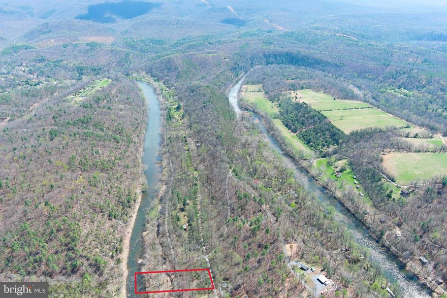 RIVER FRONT....BARGAIN HUNT.....1.19 ACRES WITH 145 FT OF USABLE FRONTAGE ON WV'S CLEANEST RIVER "THE CACAPON" COVERED IN TOWERING POPLAR TREES, PLENTY OF LEVEL SPACE FOR YOUR CAMPER OR TO BUILD AN ELEVATED CABIN. THE ENTIRE LOT IS IN THE FLOOD ZONE BUT IT MAY BE POSSIBLE TO BUILD ON PILINGS OR STILTS 10-12 FT OR SO UP TO BE OUT OF THE FLOOD ZONE. YOU'LL PASS BY ELEVATED CABINS ON THE WAY THERE TO GIVE YOU AN IDEA.  AT A MINIMUM, IT WOULD SERVE AS A GREAT CAMP LOT. WHY SO CHEAP? YOU HAVE TO CROSS OVER A BACKWATER TO GET TO THE RIVER, DURING THE SUMMER CAMP SEASON, THIS BACK CHANNEL IS MOSTLY DRY. WHEN YOU GET TO THE RIVER, IT'S FANTASTIC.....ALL 145 FT OF FRONTAGE IS ON A HUGE FLAT ROCK BAR. THE CATCH HERE IS THAT YOU'RE NOT GONNA GET YOUR CAMPER RIGHT TO THE RIVERS EDGE, ABOUT 200 FT BACK IS AS CLOSE AS YOU'LL GET BUT THAT PUTS YOU CLOSER TO THE ELECTRIC. THIS PROPERTY IS A KEEPER......IT'S TIME TO START YOUR OWN FAMILY LEGACY OF SUMMER FUN.....CAMP, FISH, SWIM, CANOE, KAYAK, TUBE OR JUST SET YOU CAMP CHAIR IN THE RIVER AND ENJOY YOUR FAVORITE BEVERAGE ON A HOT SUMMER DAY! HANDS DOWN THE BEST DEAL YOU'RE GONNA FIND ON THE RIVER.....FOR THOSE WITH SOME VISION, THIS COULD BE A REAL GEM. DON'T LET THIS BE THE BIG FISH THAT GOT AWAY, SET THE HOOK ON THIS DEAL TODAY!
