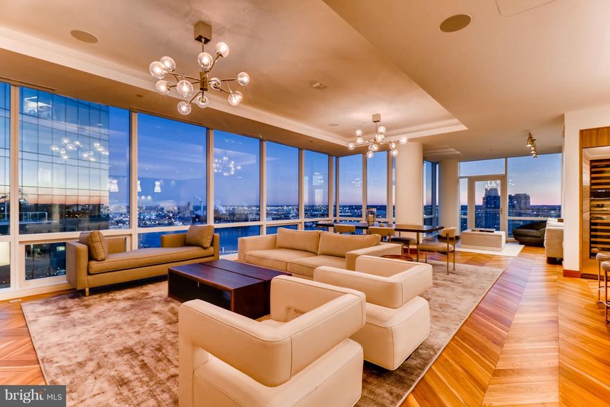 This top floor two bedroom with library, two and one half bath corner Four Seasons Private Residence is positioned 23 stories above the city offering sweeping views of the Patapsco River, the downtown skyline and Baltimore"s Inner Harbor. Boasting over 2,500 square feet this breathtaking residence presents an expansive open-concept living room, dining room, and kitchen, airy 10-ft ceilings, floor to ceiling windows, oversized balcony, vaulted ceilings, solid walnut herringbone wood flooring, designer light fixtures, custom built-ins, motorized shades and an integrated home automation system. The state of the art kitchen showcases an oversized eat-in marble waterfall island, professional-grade Miele appliances, Eggersmann cabinetry and custom Sub-Zero built-in wine refrigeration. The luminous master bedroom suite is a sanctuary featuring a separate dressing room, generous walk-in closet and an luxurious marble en-suite master bath with dual vanity, a walk-in steam shower and free standing soaking tub. Four Seasons Private Residence Baltimore provides a unique opportunity to experience life in the most sought-after location in Harbor East. With signature Four Seasons service and outstanding amenities on their doorstep, owners enjoy unparalleled access to a personally tailored lifestyle, while our long-term property management ensures a worry-free ownership experience.