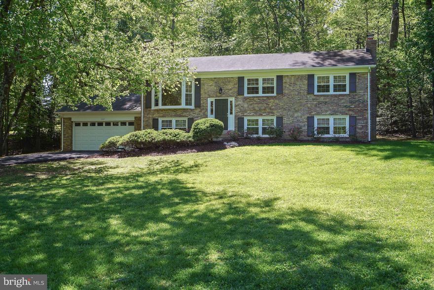 Tucked away in a peaceful, wooded cul-de-sac setting, this beautifully maintained 4-bedroom, 3-bathroom home offers the perfect blend of privacy and convenience — just minutes from Reston, Fairfax, and all major commuter routes. Completely rebuilt nine years ago and freshly updated with new carpet and paint throughout, this two-level home is truly move-in ready. The main level welcomes you with a spacious living and dining room combination featuring a stunning bay window that floods the space with natural light. The adjacent sunroom addition is perfect for morning coffee or relaxing evenings, with serene views of the surrounding trees. The kitchen boasts a center island and stainless steel appliances, ideal for both everyday meals and entertaining. Cozy up by any of the home's three fireplaces — a highlight of both the main living areas and the generous primary bedroom, which features its own wood-burning fireplace for a truly retreat-like feel. The lower level offers a large family room anchored by a third wood-burning fireplace, perfect for gatherings or a quiet night in. Additional features include a two-car garage and a half-acre lot that provides room to roam while maintaining a private, nature-filled atmosphere. This is the kind of home that's hard to find — updated, spacious, and set in a serene wooded enclave while keeping you close to everything Northern Virginia has to offer. Open House 4/26, 1-3pm.