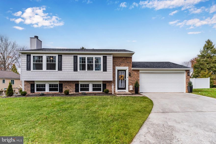 Nestled in the sought-after Countryside neighborhood along the Conodoguinet Creek, this beautifully updated Hampden Township home is truly move-in ready. Thoughtful craftsmanship and numerous upgrades shine throughout. The open main level features a stylish Kitchen with cherry cabinetry, granite countertops, stainless steel appliances, a tile backsplash, and modern pendant lighting. The adjoining dining area flows seamlessly into the spacious Living Room, creating an inviting space for everyday living and entertaining. Two well-sized main-floor bedrooms offer like-new carpet and excellent closet storage, with convenient access to an updated full bath showcasing a tile tub/shower and an oversized vanity. The Lower Level adds even more versatility with a generous Family Room accented by a whitewashed brick fireplace and mantle, plus two additional bedrooms—one currently serving as an office enhanced by French doors. A second full bath features a walk-in shower and a charming shiplap accent wall behind the new vanity. Extensive renovations in 2023 include a new roof, new siding, and windows, and the current owner has further improved the property with an expanded deck, privacy fencing, and a paver patio. Durable Luxury Vinyl Plank flooring through most of the home and light, neutral tones. Additional highlights include a two-car garage, central air, efficient gas heat, and gas hot water. Located on a quiet cul-de-sac just steps from the creek and minutes to West Shore Country Club, shopping, and major conveniences. Low Hampden Township taxes and Cumberland Valley Schools. A wonderful opportunity—be sure to schedule your showing today!