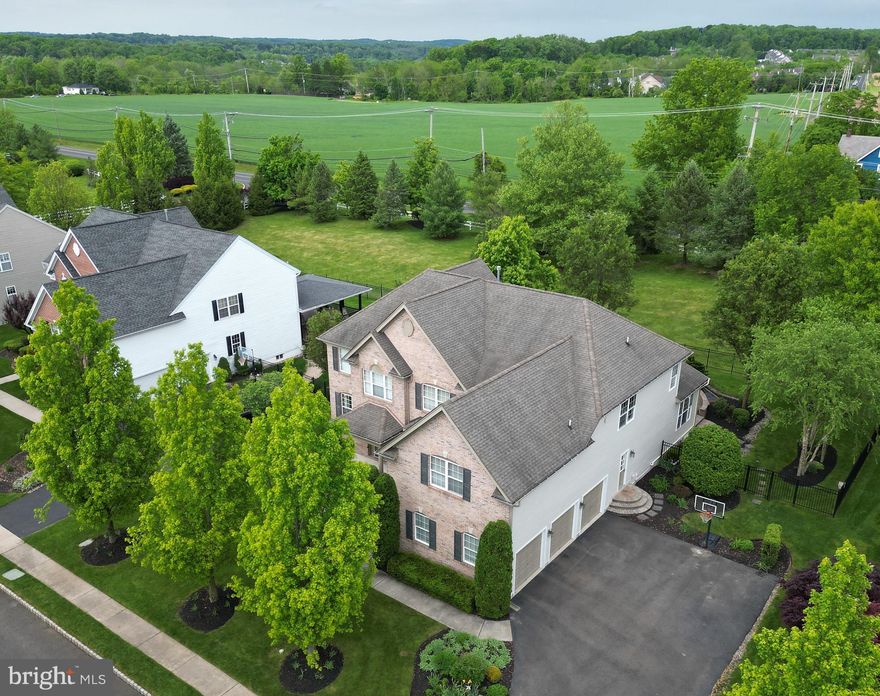 Nestled in the coveted community of Devonshire Estates, this exquisite HardiePlank  and Brick Home exudes elegance and luxury. Boasting Six / Seven bedrooms and 5 Baths, this residence is tailor-made for the discerning homeowner seeking the epitome of comfort and sophistication. As you step through the grand entrance, a sense of opulence envelopes you in the breathtaking 2-story foyer adorned with gleaming hardwood floors that gracefully extend throughout the main floor. Enhanced with upgraded moldings, every detail speaks to a commitment to craftsmanship and style. Entertain with ease in the sprawling formal dining room and living room, where a cozy gas fireplace invites intimate gatherings. Beyond lies a versatile first-floor bedroom or office, accompanied by a convenient full bathroom, offering flexibility and convenience for guests or professional needs. The heart of the home, the spacious kitchen, is a culinary enthusiast's dream, boasting top-of-the-line amenities including a gas cooktop, granite countertops, and a magnificent granite island with ample seating and storage. Premium appliances, including a Whirlpool ice maker and climate-controlled beverage refrigerator, elevate the culinary experience, while the sun-filled morning room beckons with its vaulted ceiling and seamless flow to the EP Henry Paved Patio, creating an idyllic setting for outdoor entertaining. Unwind in the inviting two-story family room, where a marble-surround gas fireplace sets the ambiance, complemented by a rear staircase leading to the upper level. A generously-sized laundry room adds convenience to the main level, ensuring effortless daily routines. Retreat to the luxurious main bedroom sanctuary, featuring a tray ceiling, sitting room, and two walk-in custom-built closets. Indulge in the spa-like ensuite bath with double vanity, offering a serene escape from the demands of daily life. Four more bedrooms, including a newly added bedroom with access to the jack and jill bathroom and additional hall bathroom provide ample space for family and guests, each exuding comfort and charm. Discover endless possibilities in the must-see daylight walkout basement, where a stunning custom-built bar and entertainment area beckon for lively gatherings. A private bedroom, home gym, and full bathroom offer additional flexibility and functionality, elevating this space to the epitome of luxury living. Nestled within the award-winning Central Bucks School District, this home offers unparalleled convenience with easy access to Philadelphia, New Jersey, New York, and surrounding counties. Explore the rich history of nearby Doylestown, indulge in a plethora of shopping and dining options, or immerse yourself in local museums, all within reach of this exceptional residence. With pride in ownership evident in every detail, this home stands as a testament to impeccable taste and timeless sophistication, offering a rare opportunity to experience the pinnacle of suburban luxury living.