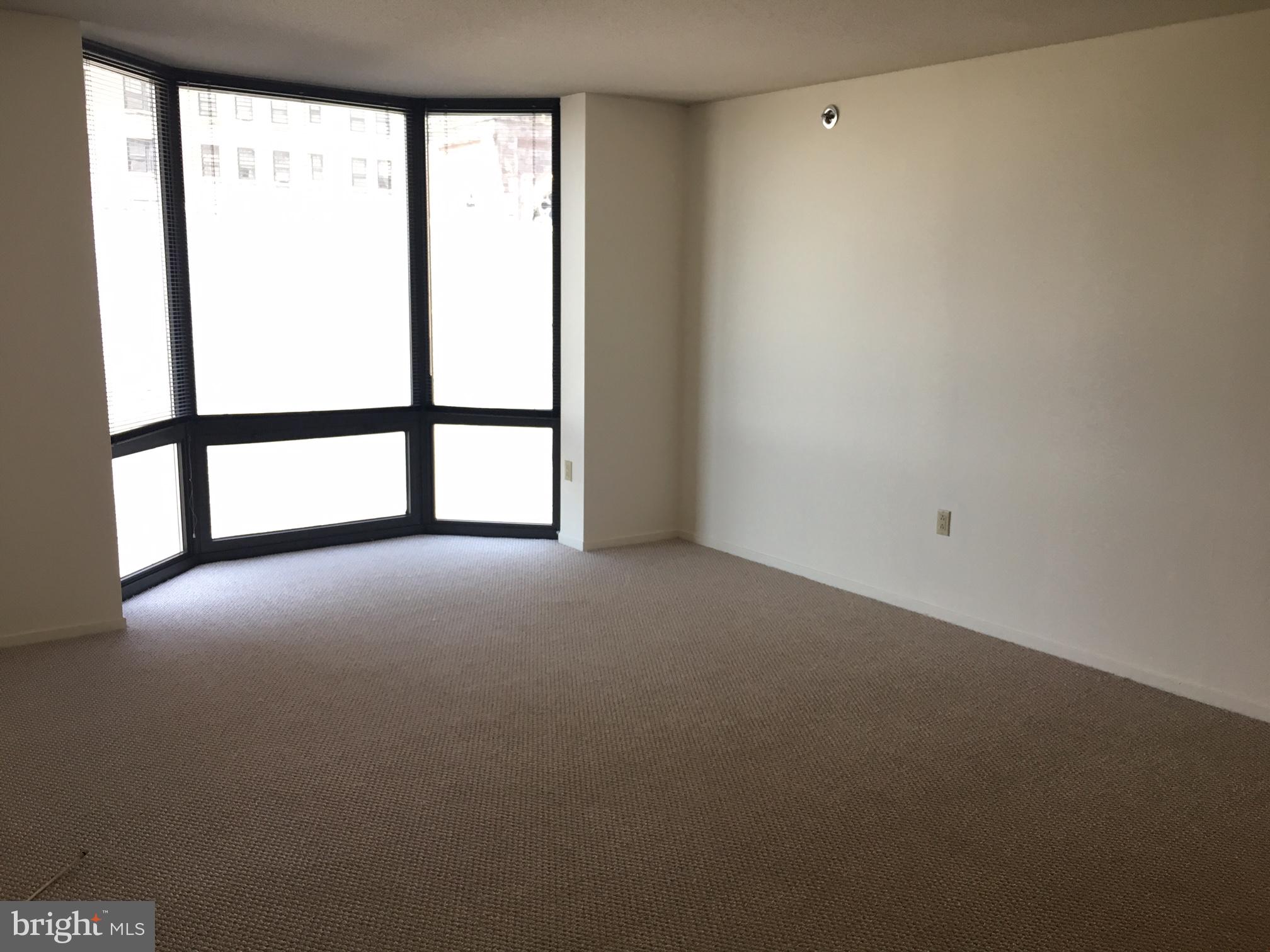 One bedroom with bay windows showcasing city views to the west at The Wanamaker House, just one block from Rittenhouse Square! Upon entrance of the home, there is a foyer with a double coat closet. The sun-soaked living and dining room is filled with natural light from large floor-to-ceiling windows. Open to the living/dining area is a kitchen with excellent white cabinetry space, as well as white kitchen appliances, including: refrigerator, dishwasher, oven/range, and microwave. The bedroom features a wall closet, another large bay window and enjoys use of an updated full hall bathroom with beautiful wood cabinetry, new countertops, a single vanity, and a shower/tub. Adjacent to the bedroom, there is extra closet/storage space thanks to a hall walk-in closet. Residents of The Wanamaker enjoy 24-hour front desk convenience, access to the roof top swimming pool, exercise room, sauna and on-site garage parking for a fee.