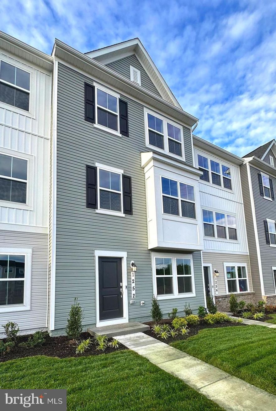 Welcome to Red Clover Meadows—a thoughtfully planned community in Ranson, WV, just minutes from historic landmarks, shopping, dining, parks, and major commuter routes. This brand-new, never-occupied Lancaster townhome features three bedrooms, two full baths, and two half baths spread across three finished levels.

The entry level offers a flexible recreation room, a powder room, and a rear-load two-car garage. On the main living level, enjoy an open-concept layout that seamlessly connects the Great Room, dining area, and a chef-inspired kitchen complete with upgraded granite countertops, cabinetry, and modern appliances. Step outside to a spacious 10x18 deck—perfect for relaxing or entertaining.

Upstairs, the owner’s suite boasts a private bath and walk-in closet, joined by two additional bedrooms and a full bath. For added convenience and style, the landlord will be installing window blinds. HOA fees are covered by the landlord.