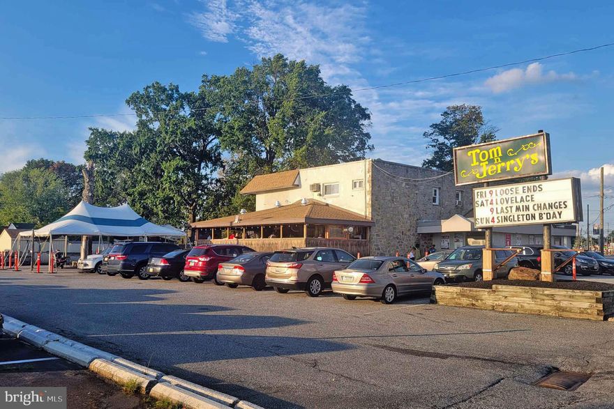 1006 MacDade Blvd, Folsom:  Endless Possibilities Await! Own a Premier Sports Bar with Incredible Potential in Delaware County. Seize this rare opportunity to own this 30-year-old and still thriving sports bar and property spanning 8 parcels (shown taxes do not include additional parcels) in a prime Delaware County location. Included in the sale is a two-story building with approximately 7,600 sq. ft. of interior space, featuring three apartments and an efficiency unit with rental potential. Multiple bars and pub food, a full basement, an outdoor covered tiki bar, dancefloor,  23 TVs, and an 11 x 6-foot big screen for ultimate entertainment.Ample parking and great visibility for high foot and vehicle traffic. This versatile property is perfect for an investor or visionary owner to maintain it as it is or ready to transform it into a bustling hotspot for banquets, restaurants, nightclubs, or new developments. The sale includes a coveted Delaware County R-Liquor License ($300,000 value). sold " as-is".  Buyer is responsible for Township Use & Occupancy certificate. Don’t let this incredible opportunity slip by—schedule a viewing today!