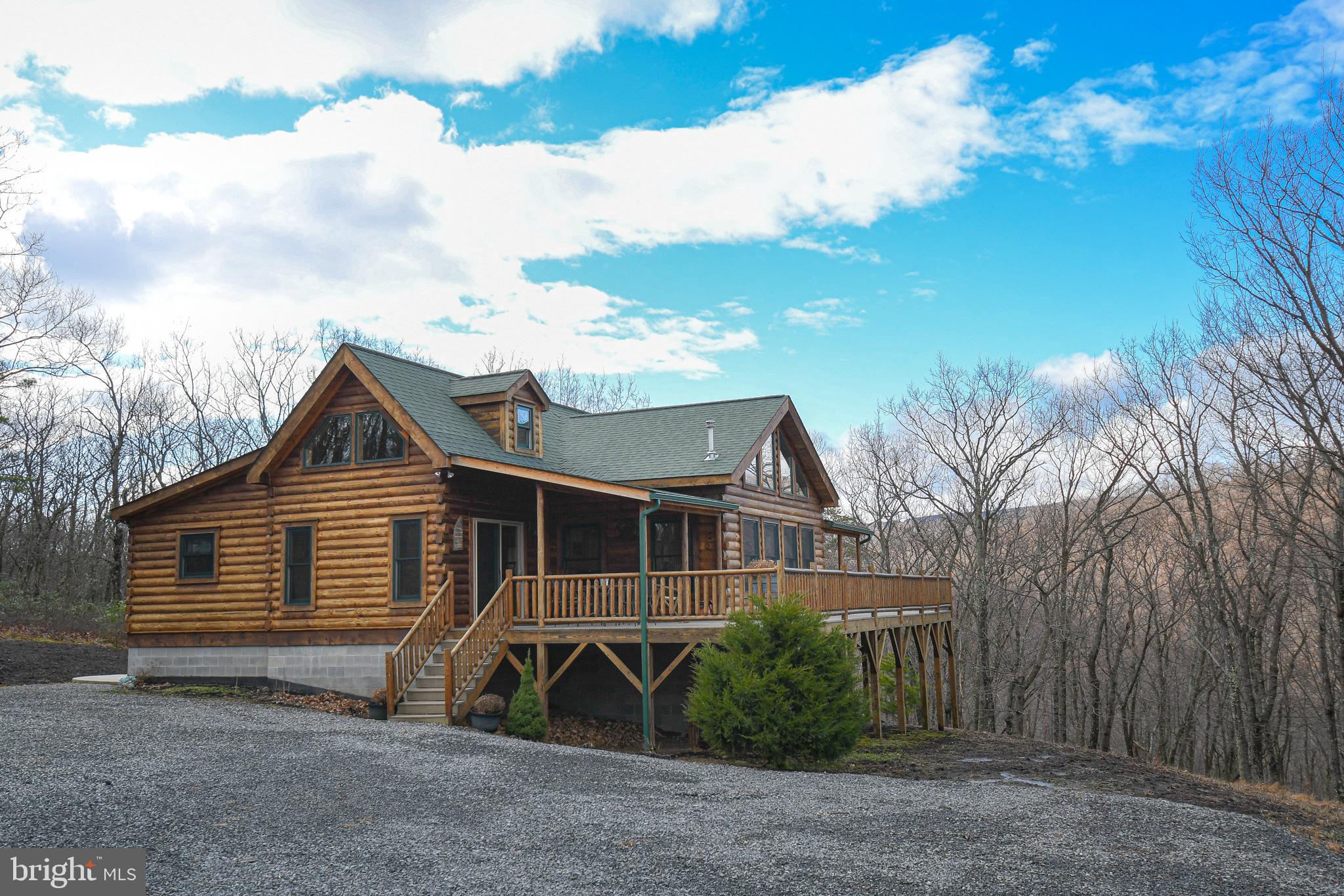 Welcome to Wild and Wonderful West Virginia! Nestled in the rolling hills sits this incredible 3 bed / 2.5 bath cabin on a whopping 10+ acres! Less than ten years old, this home boasts more than 1700 finished square feet with an entire basement ready to be finished-- even plumbed and ready for a full bath to be installed! Beautiful A-frame construction allows the natural mountain light to cascade into the living room and dining room areas. There's even a heated sidewalk leading to the hot tub!Cathedral ceilings with exposed beams provide that "mountain getaway" feel that can only be truly captured in West Virginia. Perfect for full-time living or as a weekend getaway, this is one you have to see!