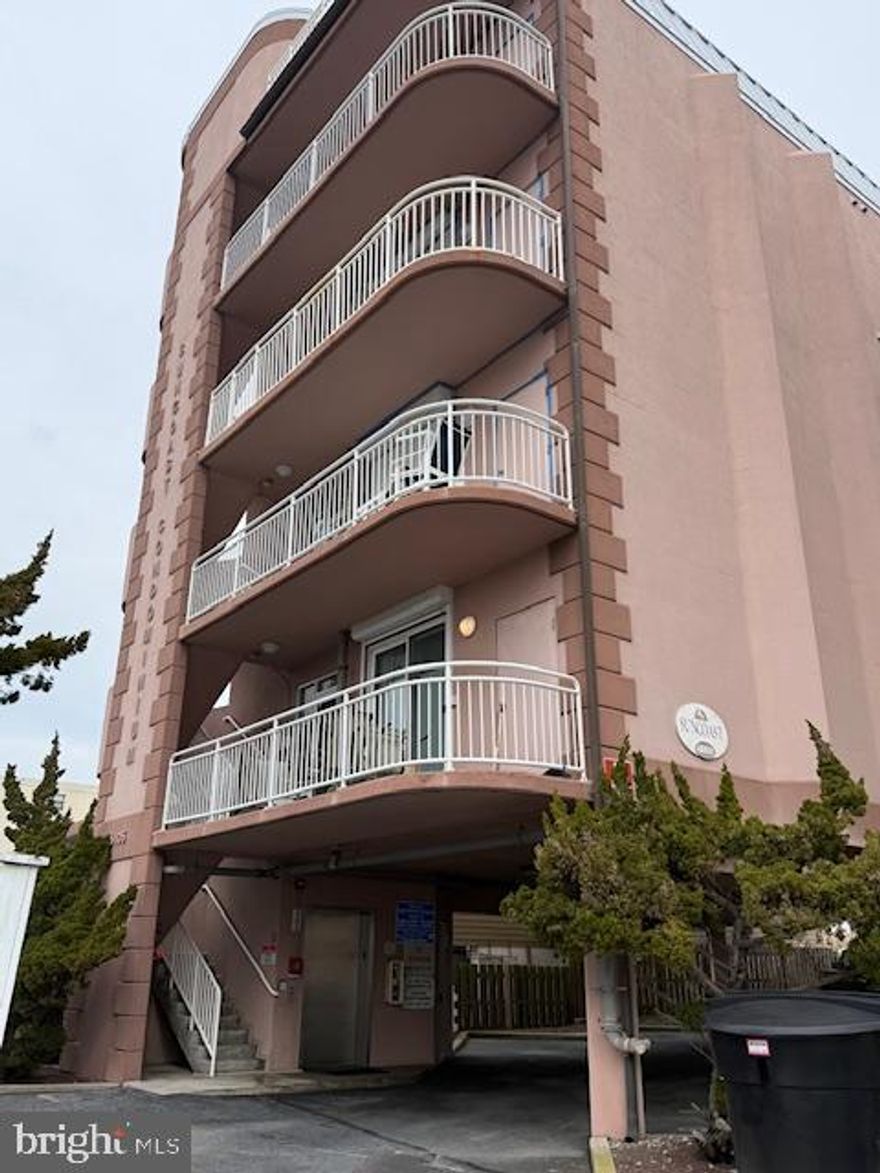 Discover a rare find on the Ocean City beachfront—an intimate four unit building offering privacy, space, and unbeatable ocean views. This 3 bedroom, 3 bath condo delivers 1,880 sq. ft. of coastal comfort, plus two assigned parking spaces and two additional guest spots. From the moment you arrive, the experience feels exclusive: enter through the west side exterior stairs or ride the keyed private elevator straight to your own lobby and front door. Inside, the layout is bright, open, and designed for easy beach living. A guest bedroom sits just off the hall—furnished and ready to enjoy—with a custom closet featuring built ins for effortless organization . Across the hall, the sunny south guest suite offers a double slider to the west facing balcony, where you can soak up year round sunsets and warm winter light. This bedroom also includes its own full bath for added convenience. Continue down the hall to find a large coat closet and a  dedicated laundry area with full size Whirlpool appliances and open shelving. Then the home opens up into a dramatic living, dining, and kitchen space with 10 foot ceilings and plenty of room to entertain. The wet bar—with Corian countertops, wine cooler, sink, and generous cabinetry—sets the tone for gatherings, while the expansive kitchen offers KraftMaid cabinetry, Corian counters, a radiant cooktop, built in oven, and thoughtful storage upgrades like pull out shelves and a lazy Susan. The living area features a natural gas fireplace, built in shelving, and an LG TV with speakers already in place. From here, step into the spacious main bedroom, complete with access to the oceanfront balcony and abundant natural light. The ensuite bath includes a jetted tub, walk in shower, double sinks, a seated vanity area, and separate linen and clothing closets—your own private retreat by the sea . The building is also undergoing its routine exterior refresh—caulking, coating, and painting—part of a proactive maintenance schedule completed every 5–6 years by the owners and management team. If you’re looking for a beachfront home that combines privacy, space, and stunning views with the ease of condo living, this one delivers it all.