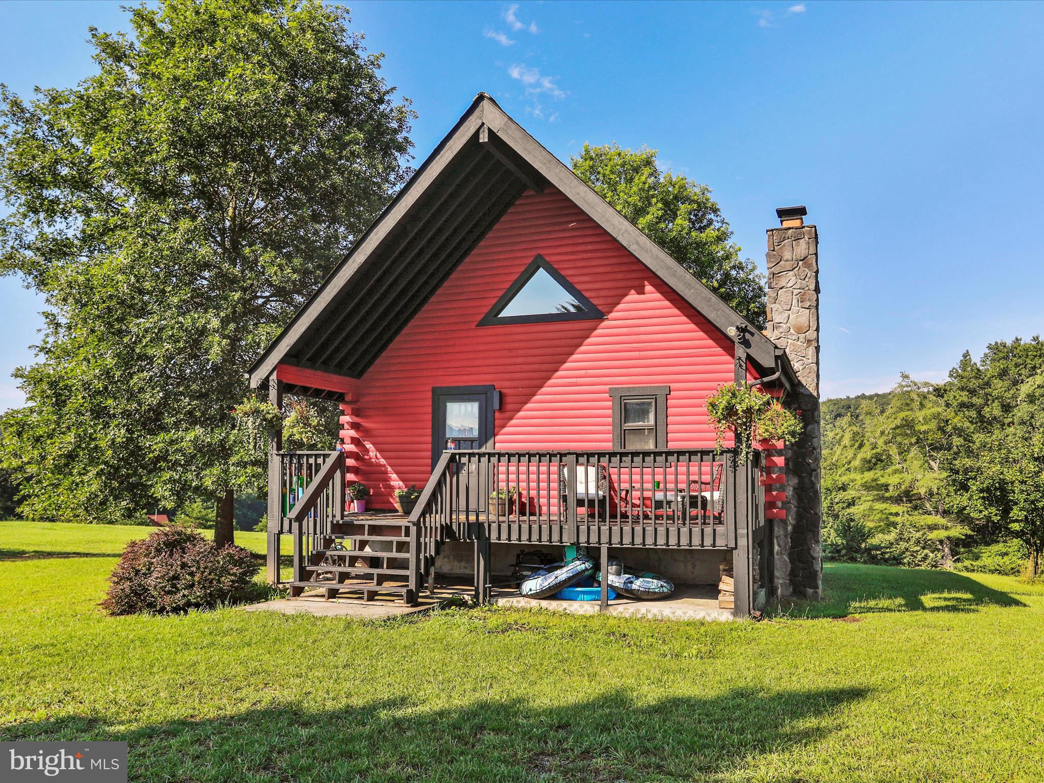 Back on the market with a facelift. Here it is! Log home built like a fortress in an upscale gated community. Private access to the Cacapon River which is by far the cleanest river in WV. This is a place to enjoy nature and make memories that will last a lifetime. Relax on your covered front porch and listen to the sounds of nature or watch the stars ( yes you can see them here ) from the open back porch. Unlike most homes in the neighborhood, the lot is not wooded or very steep and is 90% useable. There is plenty of room for a couple of horses or a big garage for the car guy or hobbyist.
The home is clean and in move in condition. There is some nice woodwork to add rustic charm and character. Owner has started to finish the basement for a possible third and fourth bedroom. Come see this today before it's gone. No lockbox and by appointment only ( owners work variable shifts) Thanks