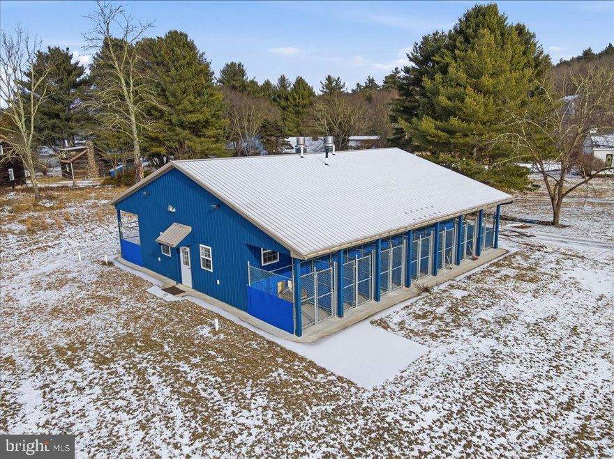 Exceptional opportunity on 27.86 acres of level, cleared land with substantial infrastructure and improvements, offering outstanding potential for commercial, residential, hospitality, or mixed-use development. This one-of-a-kind property features approximately 27,500± SF across multiple structures, including two homes, six cottages, two reception halls, a chapel, barns, and additional outbuildings. Many of the original buildings were constructed using timber harvested directly from the land, showcasing rare craftsmanship, character, and historic appeal. Beautiful stone fireplaces are featured throughout many of the buildings, adding warmth and timeless architectural charm. The property offers robust utilities including 600-amp electrical service and an outdoor wood-burning furnace serving as one of the heat sources. Additional highlights include an ultra-modern 24-dog kennel featuring radiant heat, central air conditioning, an exam room, and washroom, as well as an on-site pond and ample space suitable for farm animals or agricultural use. The property currently includes a 5,600± SF residential home, adding immediate usability and flexibility. A truly unique property with scale, flexibility, and infrastructure rarely found in the Pocono Mountains.