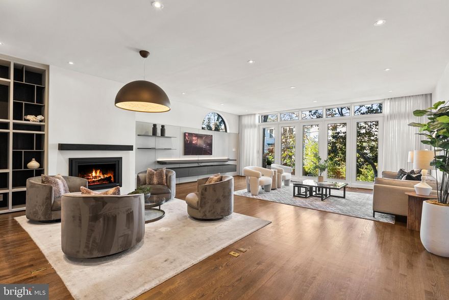 Modern sophistication and timeless Georgetown elegance converge at 1914 35th Street NW — a nearly 6,000-square-foot residence across four beautifully finished levels served by an elevator to all floors. Built in 1984 and thoughtfully updated for today’s lifestyle, this home blends contemporary design with classic proportions in one of the neighborhood’s most convenient locations.

The main level is anchored by a striking, recently renovated kitchen with Scavolini cabinetry, Miele appliances, Porcelanosa stone countertops and a built-in banquette — a perfect balance of form and function. Elegant formal living and dining rooms provide ideal entertaining spaces, while large windows invite abundant natural light throughout. The expansive living room offers soaring 9’7” ceilings, a fireplace, built-in Poliform cabinetry, and direct access to the patio and garden, making it a true gathering space full of drama.

The luxurious primary suite features a seating area, generous wardrobe room, spa-inspired bath, sauna, and a private roofdeck balcony. Three additional bedrooms, a library with fireplace, an exercise room, and four and a half baths offer exceptional flexibility for family or guests. An additional roofdeck balcony with city views and a stunning, two-tiered rear patio and garden extend the living space outdoors, creating a seamless connection between indoor comfort and open-air enjoyment. Additional highlights include several updated secondary baths, elevator access to every level, multiple skylights, and a 2-car tandem garage with driveway parking. 

With no neighbors across the street and sited around the corner from Glover Archbold Park, the home is private and close to nearby parks and greenery. Perfectly situated just moments from Georgetown’s renowned shops, restaurants, and waterfront parks, this remarkable home captures the best of modern living in one of Washington’s most storied neighborhoods.