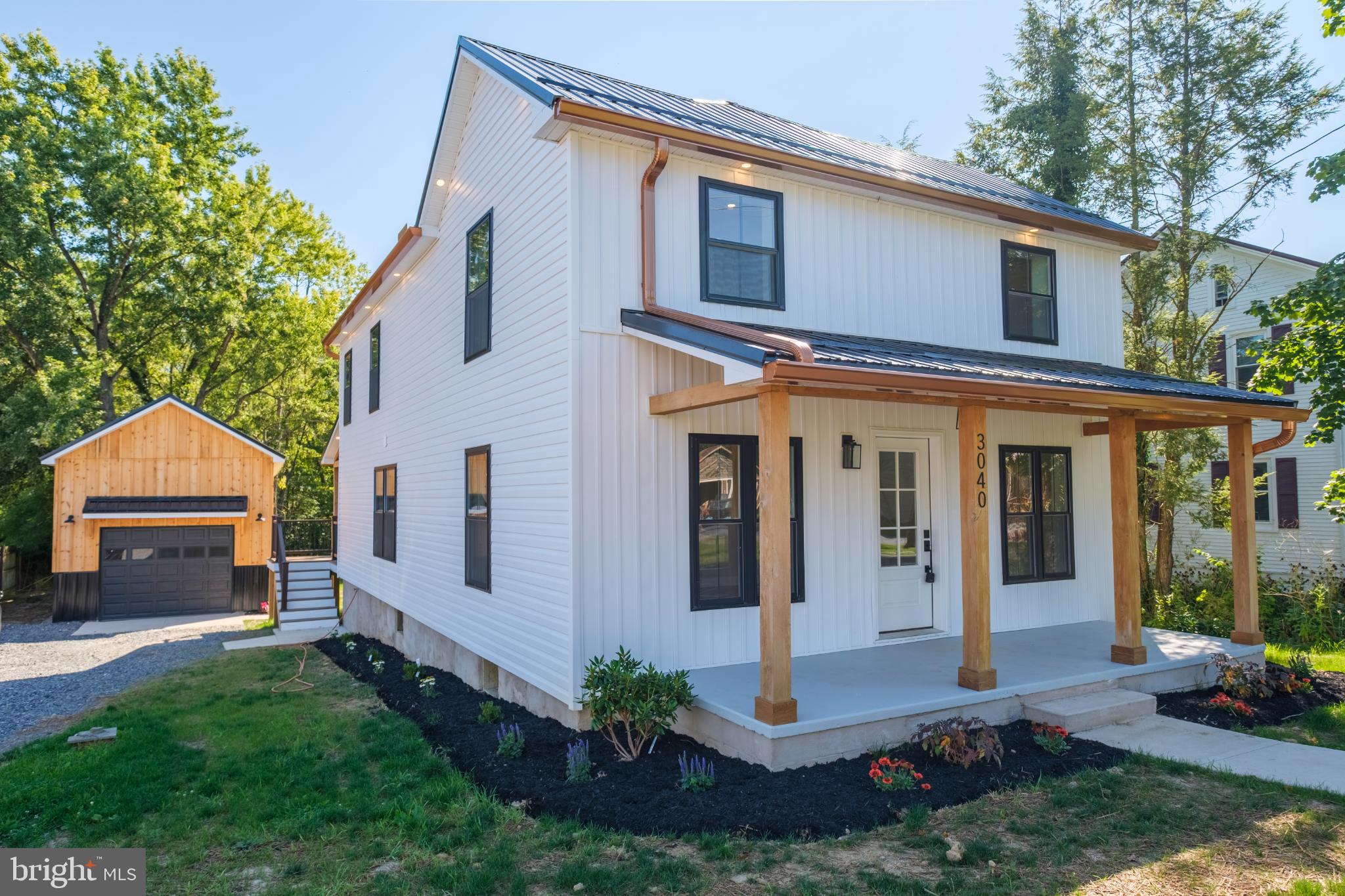 All shiny & new, waiting for you. From top to bottom, inside & out, this completely remodeled modern farmhouse-style home is ready for its next chapter. Gracefully situated on 1.82 quiet country acres within the Mifflinburg School District, this charming two-story offers the perfect blend of style, comfort & a thoughtful redesign featuring top-of-the-line upgrades throughout. The exterior boasts a brand-new metal roof, new vinyl siding, replacement windows & an inviting covered front porch, setting the tone for what’s to come. Inside, the transformation is truly comprehensive, taken down to the studs & rebuilt with new drywall, insulation, wiring, PEX water lines, PVC sewer lines, a 200 AMP panel, water heater, two heat pumps, central air conditioning, outlets & switches. Step into a freshly painted interior featuring luxury vinyl plank flooring, recessed lighting & stylish fixtures throughout. The spacious living room flows into a stunning eat-in kitchen with granite countertops, sleek white cabinetry, breakfast bar, subway tile backsplash & a single bowl undermount sink with a gooseneck faucet. A pot filler above the range makes filling large pans a breeze, perfect for home chefs & busy households alike. Brand-new appliances are included & a delightful dining area completes this thoughtfully designed space. A cozy mudroom opens onto a rear-covered deck overlooking the peaceful partially wooded backyard. For those who love to entertain, the butler’s pantry is a standout feature, offering a built-in microwave, wine refrigerator, deep farmhouse sink, granite countertops & additional cabinetry for storage. A large brand-new half bathroom with tile flooring & a generously sized storage closet completes the main floor. The hardwood staircase leads you upstairs to a relaxing primary suite with an accent wall, a large walk-in closet featuring custom built-ins & a private full bath with tile flooring, dual vanity, a gorgeous tile walk-in shower & a linen closet. Two well-appointed bedrooms share a second full bathroom with tile flooring, a dual vanity, linen closet, tub & tile surround shower. The second-floor laundry room adds convenience & includes a washer, dryer plus a utility sink & a handy hallway linen closet for storage. The full unfinished walk-out basement provides ample storage & the detached oversized two-car garage also features a new metal roof. Located off the beaten path yet within 10 minutes from Mifflinburg, Lewisburg & Bucknell University, this home offers the perfect balance of privacy & accessibility. All that’s missing is you.
