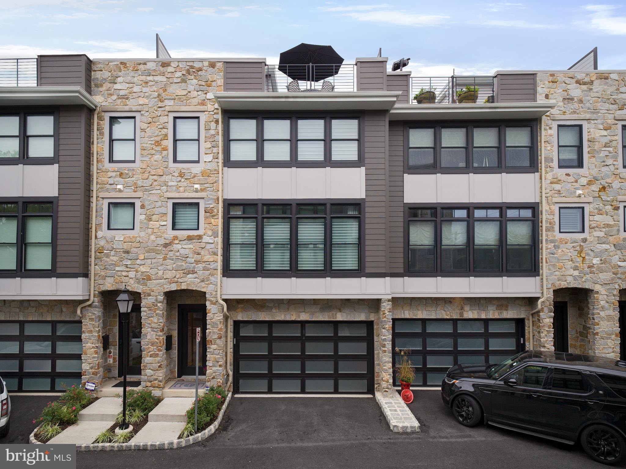 Seize the chance to own a stunning 3,400 sq ft luxury townhome in the highly sought-after community of The Brownstones at Berkley, where only 7 limited residences have been built.
Upon entering the home, you're greeted by a welcoming foyer leading to a spacious flex room, currently styled as a bedroom with a full bathroom, along with convenient access to the 2-car garage and a mudroom.
The main living level is an entertainer’s dream, boasting soaring 10' ceilings, a seamless open floor plan, and an expansive great room with oversized windows featuring custom window treatments. A gas linear fireplace with custom built-ins adds warmth and elegance.
The gourmet kitchen is every chef's delight. It features custom cabinetry, an impressive 12-foot double-sided island for ample storage and entertaining, upgraded quartz countertops, JennAir stainless steel appliances, and stunning custom lighting. Opposite the kitchen, you’ll find a pantry and a sleek wet bar – perfect for hosting gatherings. The adjacent dining area is spacious enough for large dinner parties. Just a few steps up and tucked discreetly away is a beautifully appointed powder room, complete with custom cabinetry and extra storage.
On the upper level, the primary bedroom suite offers the perfect retreat, complete with space for a king-size bed, a spacious custom closet with a vanity area, and a luxurious en-suite bathroom featuring a large double-sink vanity, walk-in shower with frameless glass doors, custom tile, and a separate water closet. Down the hall are two generously sized bedrooms, each featuring custom closets, a well-appointed hall bathroom, and a dedicated laundry room.
The fourth-floor loft adds extra living space, ideal as a TV room, home office, or additional bedroom. A half bath and a custom outfitted closet complete the loft space. The crown jewel of the home is the expansive private rooftop terrace, perfect for sunset gatherings, complete with an outdoor kitchen to enjoy luxurious outdoor living.
This exquisite townhome also features a 4-stop elevator providing easy access to every level and ample storage throughout. Custom closets and custom window treatments are found throughout the entire home, offering both style and convenience.
In addition to its luxurious amenities, the home boasts exceptional walkability to local shops, restaurants, the R-5 train line, and the famous Devon Horse Show.
Don’t miss the opportunity to experience sophisticated living in this remarkable community.