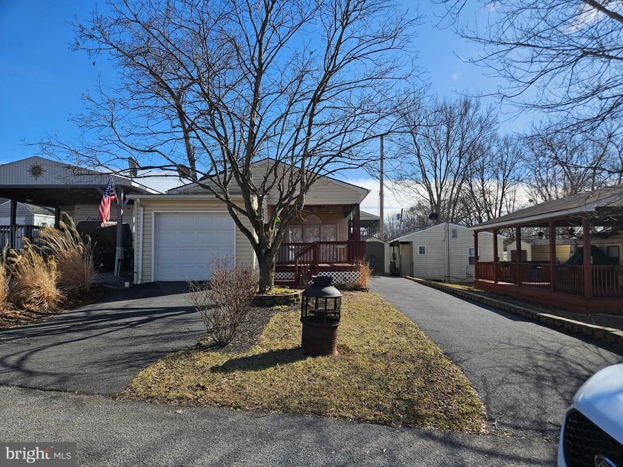 * Coming Soon* The 2026 Dues have been paid in full for the year! We will have new photos soon as well. Financing Could be available. They require a minimum of 25% down of purchase price or appraised value whichever is less plus closing costs. Our maximum loan term is 15 years. The property CANNOT be in the flood plain. Minimum credit score of 700. 

  Spacious 2 Bedroom 2 Bath Rancher (ON SEWER) w/ 10 + ft ceilings, recessed lighting and fans with a built-on garage to house the very well taken care of lifted 4-seater Club Car that conveys!  Both of the bedrooms come fully furnished with Queen bedroom sets, window a/c units, 2 Tvs, and more. Everything you see conveys. The kitchen has a new refrigerator, countertop convection, microwave oven, and soft close cabinets. Fully stocked. This is your move in ready, seasonal home away from home. Are you a snowbird who lives in FL for the winter but want to escape that heat in the summer? Look no further. These owners have maintained the property and its landscape as well with Rose bushes and tall ornament grasses as you pull into one of the 2 paved driveways! No shortage on parking here! Some of the upgrades include custom windows, blinds, large glass patio doors that just let that natural light shine in. Outside on the covered deck you'll find the fitted retractable pull-down shades, plenty of extra electrical outlets, an  outdoor table set, and a gas grill. Turn Key Folks!

 Call today for your personal tour. Approx. 10 miles of Deep water on the Potomac River access for boating, fishing & swimming. Yearly membership ($1,987) plus a $200 initiation fee for new owners, includes water, sewer & Pump outs, electric, trash and the park amenities such as 3 pools, putt putt course, Horseshoe club, Boat club, Poker runs, Trick or Treat, Christmas in July, live bands, basketball court, tennis court, fireworks, car show, Church, restaurant, bar, convenience store (Great food), playground, volleyball, ball field and much much more. Bring your golf carts, water toys and come enjoy life!