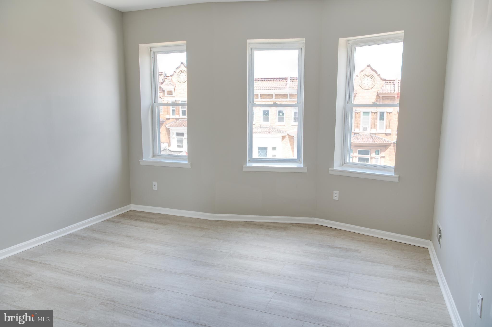 Step into style and comfort at 2100 Homewood Ave #2—a newly renovated top-floor 3-bedroom, 1-bath unit nestled in the revitalizing Midway neighborhood. This sun drenched apartment features luxury vinyl plank flooring throughout and a stunning skylight that fills the living area with natural light. Step out onto your private balcony, where you can enjoy views overlooking the park setting behind the property—perfect for morning coffee or unwinding after a long day.
Located just minutes from Johns Hopkins University, Penn Station, and Downtown Baltimore, this home offers unbeatable access to bus lines and MARC Train service—ideal for commuters and city explorers. Explore the nearby Charles Village district, filled with eclectic restaurants, cafés, and local shops. Enjoy outdoor activities at Druid Hill Park, Clifton Park, and Wyman Park Dell—all within easy reach.
