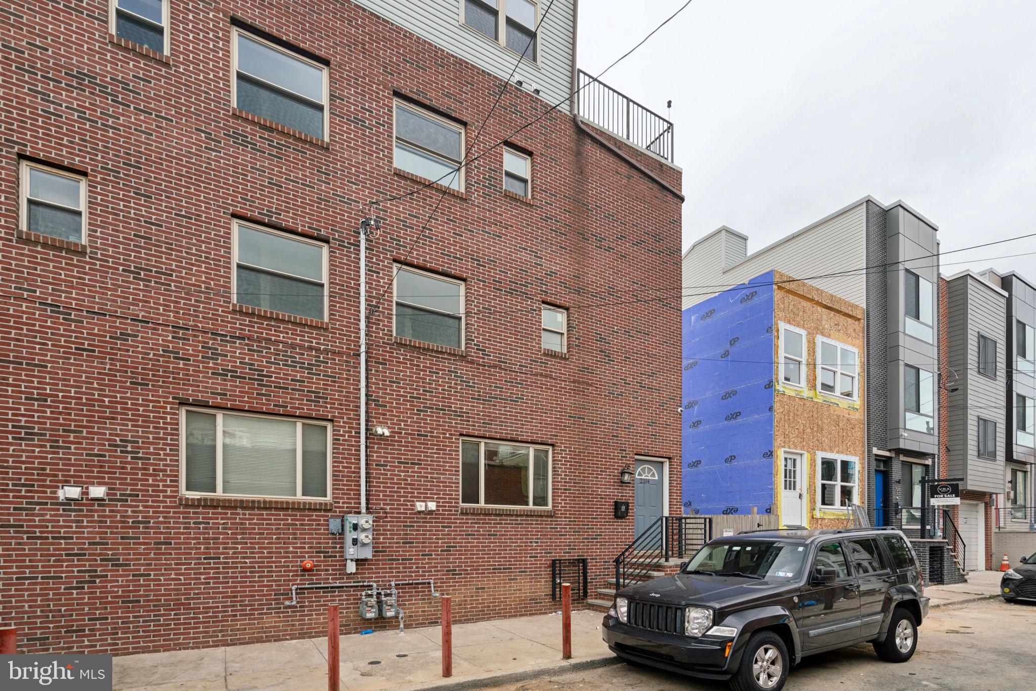 Welcome to 2114 S 7th Street, a multi-family building featuring two 3-bedroom, 3-bathroom residences with private entrances. Each home spans four levels of living space and boasts its own private roof deck. Upon entry, you'll be greeted by a spacious and sunlit living and dining area, leading into a modern kitchen equipped with sleek stone countertops, a 5-burner gas stove, white shaker cabinets, stainless steel Frigidaire appliances, and pendant lighting illuminating the large central breakfast bar. Unit 1B also enjoys the added bonus of a private rear yard. As you move to the second floor, contemporary metal railings and bright hallways guide you to the master suite, complete with an elegant en-suite bathroom showcasing a mosaic-tiled shower and a stylish vanity. On the third floor, another bedroom awaits, paired with its own en-suite bathroom featuring a pristine white-tiled tub enclosure. The top level is a true highlight—a bright and versatile space ideal for a home office, entertainment area, or study. Sliding glass doors lead to a private roof deck The finished basement provides additional living space, which could be transformed into a lounge or an extra bedroom, complete with a full bathroom and a laundry closet housing Samsung HE front-loading washer and dryer units. With a few years left on the tax abatement.