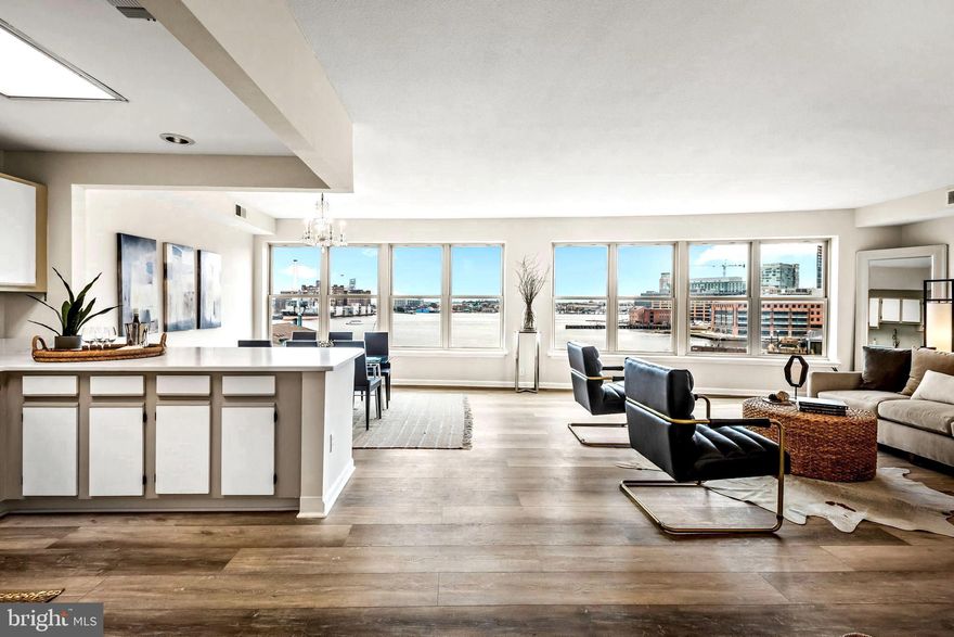 This terrific Fells Point residence is located in Belt’s Landing, a historic Fells Point waterfront condominium building.  The spacious 2 Br, 2/1 Ba condo boasts 1,617 sq. ft.  of premium urban living space with an additional 80 sq. ft. of covered balcony. Positioned on the sixth floor at the envious southwest corner of the building, the home has 180 degrees of unobstructed and expansive views of the mesmerizing Baltimore Harbor, the charming Fells Point historic district, its inlet and entertainment areas, the Pendry, local marinas, hypnotic Downtown cityscape, and various surrounding neighborhoods.  The condo has been recently updated. Features and enhancements include an inviting entry leading to the dramatic open living and dining area with a wall of windows capturing the amazing views and opening to the covered balcony.  The kitchen, which adjoins the dining area, has been updated with stainless steel appliances and quartz countertops and has an adjoining pantry for additional storage.  The en-suite primary bedroom has three generously sized closets, and the primary bath includes a soaking tub, separate shower, 72” vanity with marble top, a linen closet, and an overhead heat lamp for supplemental heating.  The second en-suite bedroom/bath includes a walk-in closet, a 42” vanity with solid surface top and a tub/shower combo.  A half bath and a separate laundry/utility room with a new stacked washer and dryer are conveniently located in the front hallway.  Additional enhancements include new windows in the living/dining areas, neutral paint and gorgeous deluxe vinyl wood plank flooring throughout.  A sixth-floor storage locker 3’ X 4’ X 8’ conveys along with two garage parking spaces – one assigned space P45 and one unassigned space. There is a monthly condo fee of $23.19 and an annual property tax of $71 for the deeded parking space. Building amenities incorporate 24 hr. front desk staffing, security cameras and monitoring, outdoor pool overlooking the Promenade and harbor, exercise room, great lobby, two elevated community courtyards, three elevators, three garage EV charging stations, concrete and steel structure, brick and stucco exterior, smoke detectors and sprinklers.  Belt’s Landing is located within proximity of Downtown Baltimore, Harbor East, Harbor Point, Canton, Butcher’s Hill, Johns Hopkins and U of M Medical campuses, institutions, major highways.  Shopping, cultural activities, restaurants and bars are all within walking distance.