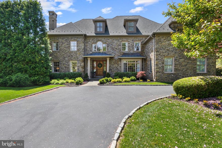 Introducing 828 Gatemore Rd, Bryn Mawr, a breathtaking, classic stone home that seamlessly blends luxury, comfort, and convenience. Situated on a picturesque, neighborhood street in the highly sought-after Bryn Mawr, Lower Merion Township, this home on a beautiful level lot, offers over 6,433 square feet of living space above ground, with an additional 1,671 square feet in the finished daylight lower level. Built in 2008, this meticulously maintained and recently updated home exudes elegance and sophistication at every turn and shows like a new home. 
As you step into the foyer, you're greeted by Brazilian cherry hardwood floors, 10 foot ceilings, solid wood doors and exquisite millwork that flows throughout the main floor. To the left, the living room with fireplace invites relaxation, while the dining room to the right with grasscloth wallpaper, wainscotting and a new chandelier sets the stage for memorable gatherings.
Prepare to be wowed by the updated chef's kitchen, featuring white custom cabinetry, marble and wood top countertops, new backsplash and lighting, and top-of-the-line Viking and Bosch and Sub Zero built-in appliances. The adjacent breakfast room with wet bar/Butler’s pantry seamlessly transitions into the grand 2-story family room, highlighted by a stunning stone gas fireplace, built-in cabinetry and balcony above. French doors open from both the kitchen’s breakfast room and family room to the oversized rear composite deck with built-in grill and stone surround deck, offering serene views of the private, landscaped backyard as well as an outdoor retreat to sit in the sun. Completing the main level is an office with built-ins, a formal powder room, and mudroom with custom built-in cubbies.
On the second floor, the primary suite awaits with a large marble bath with 2 vanities, large shower and soaking tub, and water closet. Additionally the primary suite includes a sitting room, and two walk-in closets. The 2nd bedroom has an ensuite bathroom and bedrooms 3 and 4 share a jack and jill bath, providing ample space for family and guests. The second floor also features a large laundry room and a loft area sitting room overlooking the family room.
Venture to the third floor to discover extensive finished space, including an au pair/in-law suite with a private bedroom  and full bath, as well as a large bonus room currently used as a homework space/craft room.This level provides ample space for overnight guests or for everyday living. The 3rd floor was recently painted and carpeted.
The expansive daylight lower level is an entertainer's dream, boasting a large exercise room to work out from home. A tv/family room features a gas fireplace and windows overlooking the rear. Completing the lower level is a wood bar room with natural light, an office/bonus room, and a full bath. This level was recently painted and carpeted. The lower level has doors that open to the large, level newly fenced-in yard (and dog fence as well), complete with mature trees, landscaping, outdoor lighting and the large rear deck,  perfect for outdoor living.
Additional features include a 3 car attached garage with Tesla wall charger, epoxy floor, and cabinets. A full house generator offers peace of mind during power outages. Recent home improvements additionally include replacement of second floor HVAC, replaced hot water heater, installed security system and cameras. Stucco remediation done by seller. 
Located in the prestigious Lower Merion School District and just 1.5 miles from the Bryn Mawr train station with direct service to Philadelphia and NYC, this home offers unparalleled luxury living in an unbeatable location. Inspection report available in documents section.