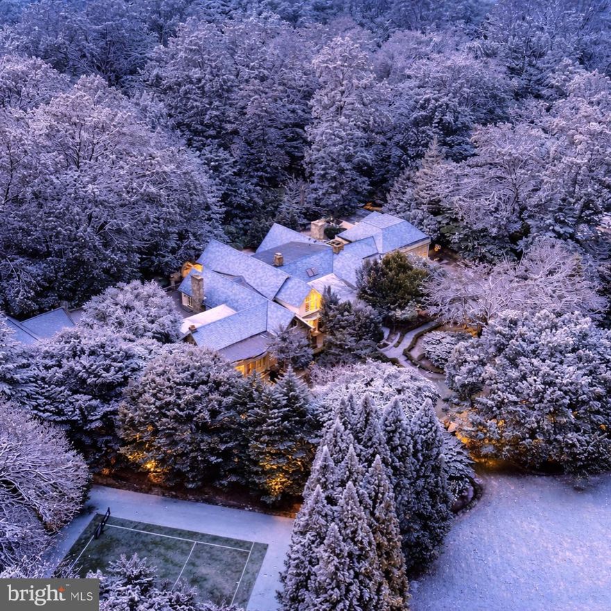 Welcome to Stone Wood, your private sanctuary. An enchanting tree-lined driveway winds through rolling greenery, guiding you to a timeless oasis set on over 5 serene acres. Originally crafted in 1984, masterfully expanded by renowned architect George Stavropoulos in 2000, and exquisitely reimagined in 2021, this estate blends classic grace with modern sophistication. Behind its gated entrance, the drive reveals a stately manor surrounded by manicured lawns, cascading fountains, vibrant gardens, and a tranquil pond beside a resurfaced large tennis court. A full gym and a beautiful guest house complete with its own kitchen further elevate the property’s resort-like appeal. Designed for both intimate living and grand entertaining, the interiors glow with natural light, showcasing intricate millwork, fine finishes, and six elegant fireplaces. The gourmet kitchen—anchored by custom cabinetry, chef-caliber appliances, and its own wood-burning hearth—flows into a cheerful breakfast room and a soaring two-story great room framed by walls of glass. The Versailles-inspired grounds, envisioned by landscape artist Charles Owen, enchant with stone fountains, French wrought-iron gates, and meandering pea gravel paths. Just minutes from Tysons Corner, McLean, Washington D.C. and Dulles Airport, Stone Wood offers refined living in a resort-like setting—an oasis of elegance, artistry, and tranquility.