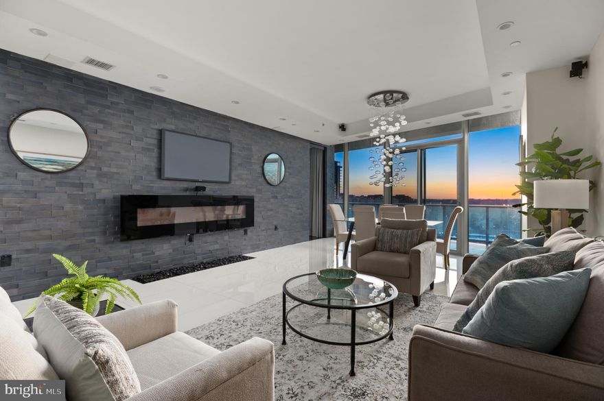 Welcome to Turnberry Tower, one of DC’s most luxurious buildings located in the Rosslyn neighborhood of Arlington, Virginia.  This fabulous penthouse features a private elevator entrance into all the space you need on one level with two bedrooms, an oversized den and two and a half bathrooms.  Enter the foyer and extended hallway to find polished porcelain floor tiles, tray ceilings, surround-sound system, and expansive views from 400 square feet of outdoor wrap-around terrace. The living area’s floor-to-ceiling windows showcase the breathtaking city & river views. The gourmet kitchen is wrapped in Italian Snaidero cabinetry and offers everything a cook would need.  Top of the line appliances with double ovens, five-burner gas cooktop with range hood and pot-filler, Sub-Zero refrigerator and freezer, built-in Miele espresso machine and beverage cooler. The spacious primary suite features terrace access and a custom designed dressing room connected to the en-suite bathroom. The luxurious primary bathroom covered in marble surround includes a double vanity, walk-in shower, and Jacuzzi. The large second bedroom, ideally located on the other side of the condo, offers city views, en-suite full bathroom, large closet and hardwood flooring. A centrally located den with sliding door, conveniently connects to the laundry room and an additional storage area. Turnberry Tower is known for its five-star amenities which include a concierge, 24/7 valet parking, fitness center, indoor pool, spa services, and owners lounge. Located in the heart of Rosslyn and walking distance to Georgetown, don’t miss out on the opportunity to make this place your home.  With these views and this fabulous price, this won't last!