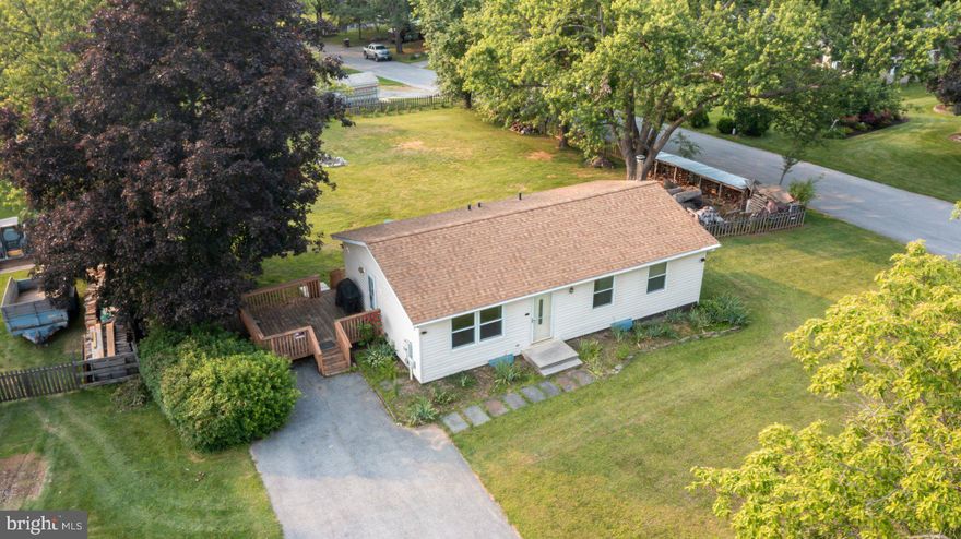 Loads of potential in this 3BR/2BA Rancher on a sprawling corner lot in Finksburg. Pull into the extra long, double wide driveway, pass by a lush green lawn and adult shade trees on the way to the front door of your new home.  Step inside to a home filled with natural light and hardwood floors.  The main living space consists of a spacious living room and an eat-in kitchen.  The kitchen features plenty of cabinets and counter space, and a double stainless sink under a window.  Down the hall are two sizable secondary bedrooms, a large primary bedroom, and a full bath.  The lower level offers additional living space featuring a full bath with a walk-in shower, a wood burning stove, laundry, storage, and a walk-out to the beautiful yard.  From the kitchen step outside to a wood deck that overlooks the yard filled with green space, adult trees, a large storage shed, and so many possibilities.  This home is located in close proximity to shopping, restaurants, and commuter routes.  
As-is, seller to make no repairs.