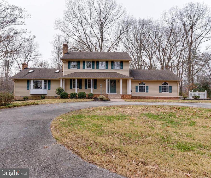 Start the New Year in your New Home! This beautiful and private home on 4 acres features 2 Primary Bedrooms! A total of 4 bedrooms and 3.5 bathrooms, with a Primary bedroom located on each level.  Come up the circular driveway to a welcoming front porch, patio, and beautiful landscaping. Once inside you will see features such as recently refinished hardwood floors. The kitchen has granite countertops, stainless steel appliances, double ovens,  a walk-in pantry that leads to the laundry room and is open to the dining area with a gas fireplace. The great room features a vaulted ceiling and a pellet stove, off of the great room is an all-purpose room surrounded by windows. The main-level Primary bedroom features an exterior door to its own patio area, his & her entrances to the bathroom with barn wood doors, his & her closets, his & her sinks, a large tiled shower, and a seated vanity area.  The upper-level Primary bedroom has a walk-in closet and a tub/shower combo. Newly added  Tesla charging station and RV hookups.  Outside you will find a deck, patios, and a 20x30 barn with a loft area. Bring the family and enjoy this slice of country heaven!! Located just minutes from 301 for easy commuting under an hour from Andrews AFB!!!