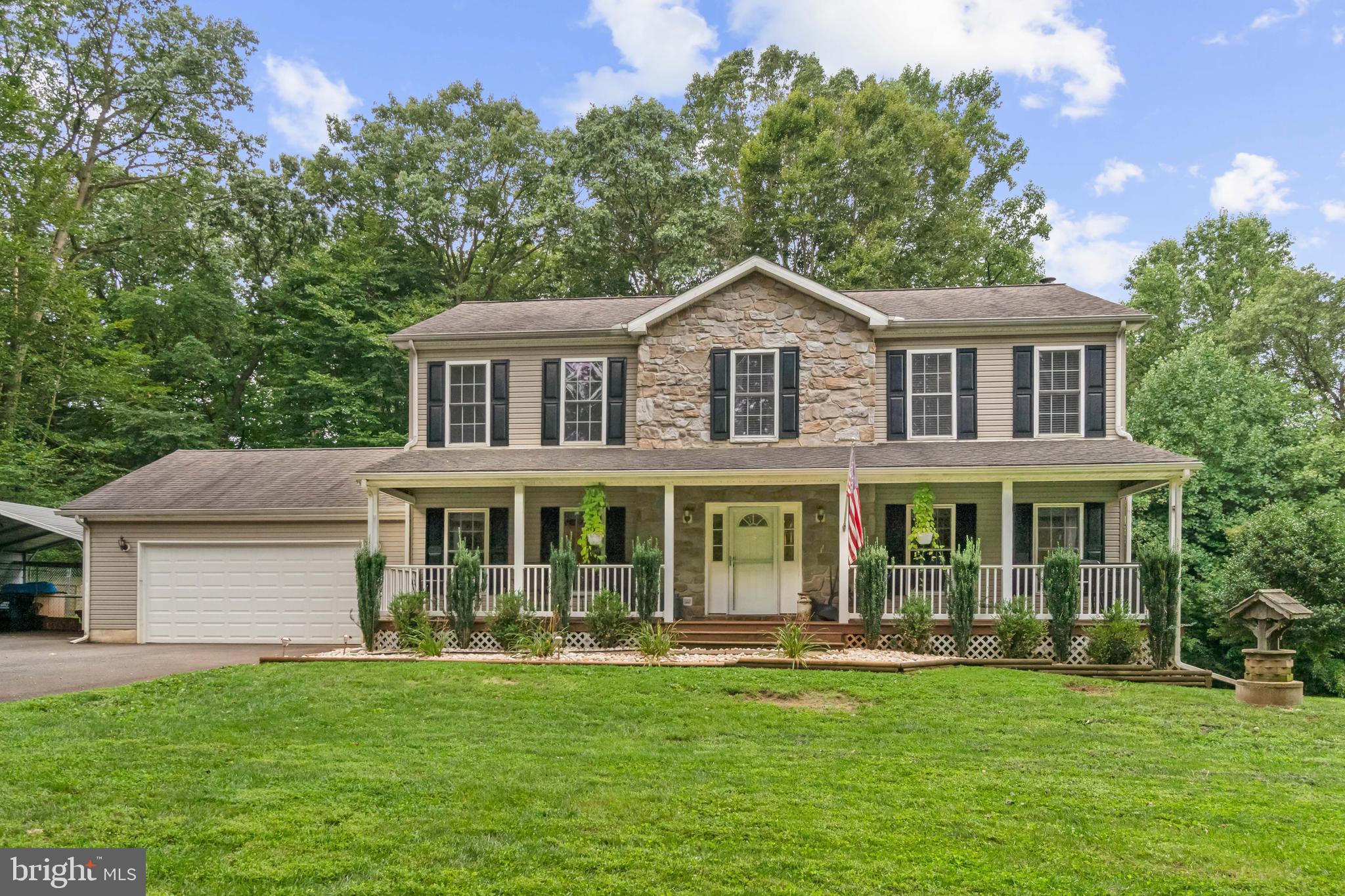 Beautiful colonial in a private country setting on an acre surrounded by trees. Large front porch, four sizable bedrooms, country kitchen with island and formal dining room, two and a half bathrooms, main level laundry, two car garage and a carport. Open foyer with hardwood floors, main level family room with woodstove and sliders to the deck. Full, unfinished basement with double doors to the outside.