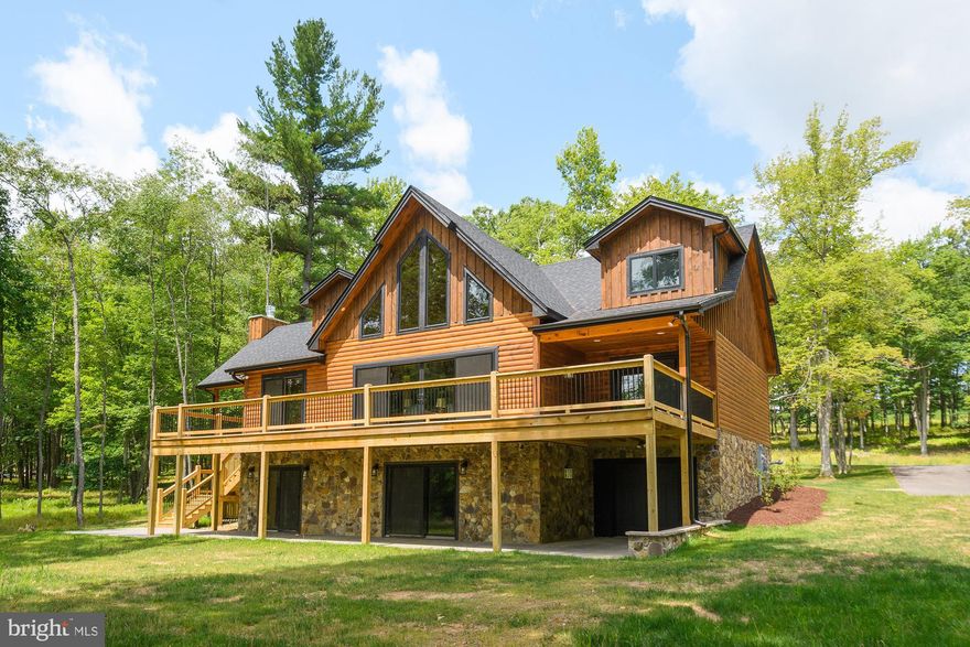 Beautiful new construction Mountaineer Log home located in the Cathedral Springs section of gorgeous Thousand Acres. This golf front home offers an open floorplan, six bedrooms, 5.5 baths, and three levels of living space. The abundance of windows brings the beauty of the outside in during any season. The outdoor living space with a stone fireplace is ideal to enjoy family and friends while you can also watch the golf course just a few feet away. The location feels so serene and private. Call today to preview this great home! Includes a golf membership to TAGC. Lake access area is near existing golf clubhouse on the lakefront. This lot does not include a dock slip, but it does have deeded lake access. Rentals are limited to 24 times per year, and no more than 3 per month.