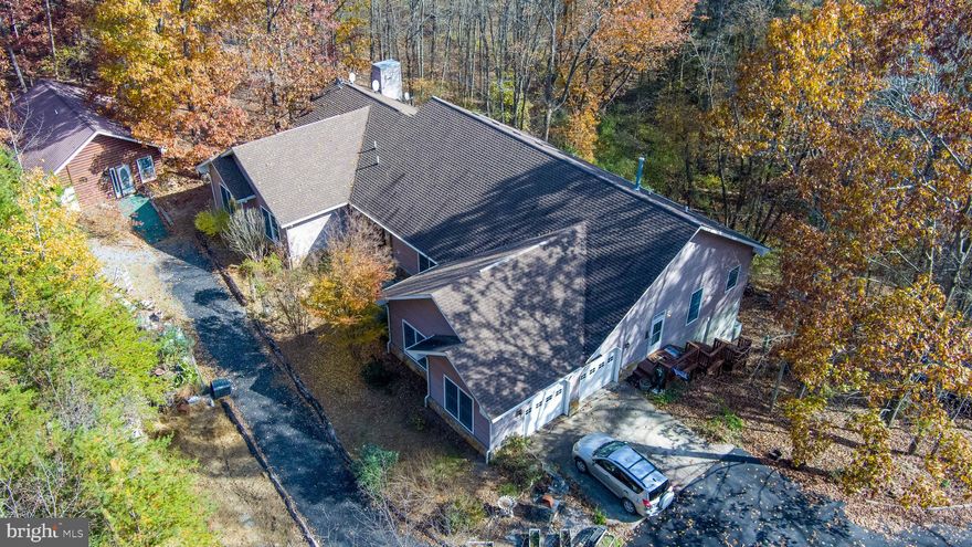 Back Creek Valley "Rivendell"  UNRESTRICTED -Peaceful private wooded 28.04 acres. Three separately deeded parcels. Nestled in the tree tops, two residences; one built in 1860 fixer upper, one built in 2002 by an  exacting engineer.   Pool house with heated endless pool.  28x40 Metal storage barn building .  Pond. Stream
Sited on 14 acres spacious, 2932 SF,   comfortable,  highly attractive ranch   house with 10' high ceilings, large living room,  opening to deck,  two gas  fireplaces, separate formal dining room,   wood floors through out, Brazilian Cherry, red oak, white oak, black walnut, ash.  Lots of light, window exposure all to south;  3x6 and 6x6 tilt wash windows,  sky lights, 9 ceiling fans,  (3) 6'x6' sliding glass doors  to 60 x 10'  foot deck overlooking the pond. 30' of deck covered.  Large primary bedroom suite with Jacuzzi walk in tub, sitting area with fireplace, opens to deck.   Additional full bath has walk in tub w/ heated seat, micro bubbles, mood lightings!!! Additional 1/2 bath.  All baths ceramic tile floors.  Large kitchen with heightened and extensive cabinetry, island, separation peninsula w/dining area. Ample storage.   Full  high ceiling walk out concrete basement, concrete floor. Ready to finish;   plumbed for bath and kitchen if desired.   Sliding glass doors to concrete  patio. Additional 8' garage door provides area for lawn equipment /car.  Two car attached  garage; possibly 3 cars will fit.  Home well insulated.  Full house generator. Well thought out for comfort and enjoyment and aesthetically attractive.  Quality home.  Furnishings negotiable.
Wooded 8.01 parcel buffers property; hike, hunt, possibly build another home. 
Guest house/ built 1860 on 5.6 acre lot, 2 story, 2 bath,  3  bedrooms, 1,280 Sq. Ft.  Separate well and septic.
 Additional building wood siding looks like log  Pool House/ spa.  Heated pool. Radiant heating. 3  Sky lights. Sleeping loft. Bath w shower and marble walls.  
AWAY FROM IT ALL.  Private, Unrestricted,  Naturally Beautiful.  Rare. A healthy place to be.   Exceptional property for the discerning buyer, for  family enjoyment, for  retirees, for nature lovers, for the sportsperson,  for work at homes to telecommute.  Fish, hunt ( hunters paradise) , hike  many possibilities, maybe Air B&B.  Close by to  Martinsburg  30 min commuter train to DC.  Close to Virginia line, WInchester Medical Center and Costco.  Close to Martinsburg WV University Hospital. 20 min to I-81.