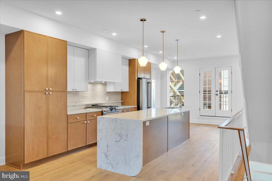 A rare chance to own a newly constructed, four-story single-family home in Rittenhouse, 522 S 17th Street stands out for its intelligent design, refined finishes, and hard-to-find garage parking—all within the Greenfield School Catchment. Developed by Waybar Development, this 4-bedroom, 3-bathroom residence includes three private outdoor spaces and a full 10-year tax abatement.

Spanning four full floors with no basement, the home features a bright and open layout with natural light on every level. The kitchen is outfitted with fluted Timber cabinetry by Fabuwood, Taj Mahal quartzite countertops, and a GE Café appliance suite, brought together with ceramic Tranquil tile accents and Sharp microwave drawer.

Bathrooms are elevated with thoughtful design elements like arch-entry glass showers, red oak vanities, subway tile walls, and Delta Trinsic fixtures in champagne bronze. The primary suite offers a generous layout with premium finishes throughout, including iron-shaded lighting and an oversized walk-in shower with rain head.

Interior details such as white iron railings, oak handrails, and wide-plank hardwood flooring tie the home together with warmth and cohesion. A private 1-car garage adds an uncommon layer of convenience, and the roof deck delivers expansive city views. With no shared walls, no HOA, and a design-forward aesthetic, this home represents a truly rare new construction offering in one of the city's most established neighborhoods. Expected delivery December 2025. Some minor customizations may be available for early buyers. Inquire today to cement your place in one of Rittenhouse’s most exclusive new construction offerings before it's gone. ** Interior photos are of a similar home by the same builder. **