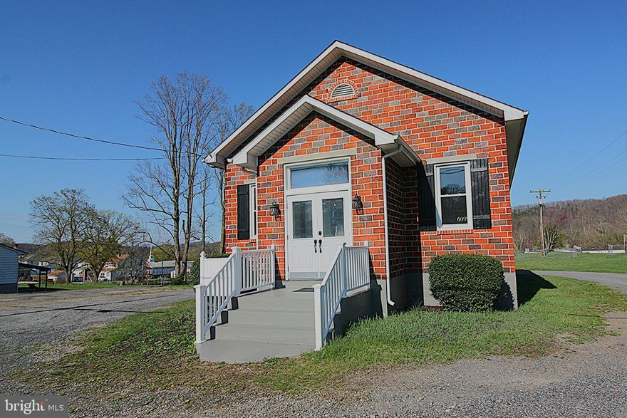 Unique opportunity in Paw Paw, WV – No zoning restrictions! Well-maintained brick building formerly used as a church, offering endless potential for residential, commercial, or community use. Features a bright main sanctuary with high ceilings and original wood pews, plus a finished basement with a full kitchen and large dining area. Ample on-site parking. Peaceful small-town setting minutes from the Potomac River and scenic byways. Ideal for homebuyers seeking a one-of-a-kind property, entrepreneurs needing flexible space, or non-profits/community organizations looking for a headquarters.