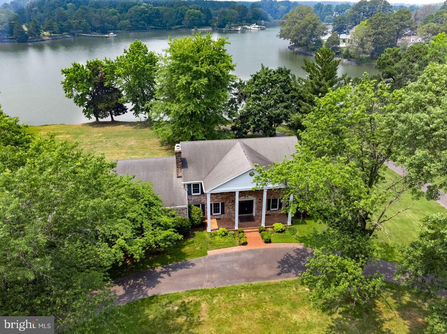 One of the most desirable locations in Talbot County, just off the Oxford / Easton corridor on deepwater Island Creek.  This large, bulkheaded property features a large (6 Bedroom) Georgian style home set on  2.5+ acres of high level waterfront with sweeping southern views.  Large dock with water and electric and a grandfathered huge covered slip with 6' MLW.
The property is at the end of World Farm Road with water views from all sides and little to no street traffic.  The house has six bedrooms, 3.5 baths with potential to convert one large bedroom to an in-law suite.  There are two stairways to the second floor.  The main level has a formal entry Foyer, Formal Living Room, Dining Room, Eat-In Kitchen, and an expansive Family Room with Wood Burning Fireplace.  Every room has water views!  There is also a service area with laundry room and a large two car garage.
The perfect retreat with loads of space and room for a riverside pool.