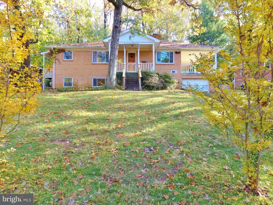 Don't miss this rare opportunity to own a home in the Lakeside subdivision of Greenbelt!  One of the few homes in town with a GARAGE.  The original owners of this custom-built home added many features.  The attached garage has a large covered porch/patio.  The kitchen has been renovated with modern wood cabinets, gas cooktop and wall oven.  The spacious living room has a stone fireplace with glass doors.  Also on the main level is the master bath & bedroom, along with 2 additional bedrooms and full bath in the hallway.  There's both a central a/c and whole house fan that vents to the attic.  The basement has an office, large family room, laundry, numerous storage closets and extra storage space.  The wooded backyard is adjacent to protected woodlands.  This home is just a few feet away the Greenbelt Lake path and Park area.  Also nearby are tennis courts, playgrounds, ballfields, theaters, restaurants, library, community center, salons, groceries and more.  There's no place like Greenbelt!