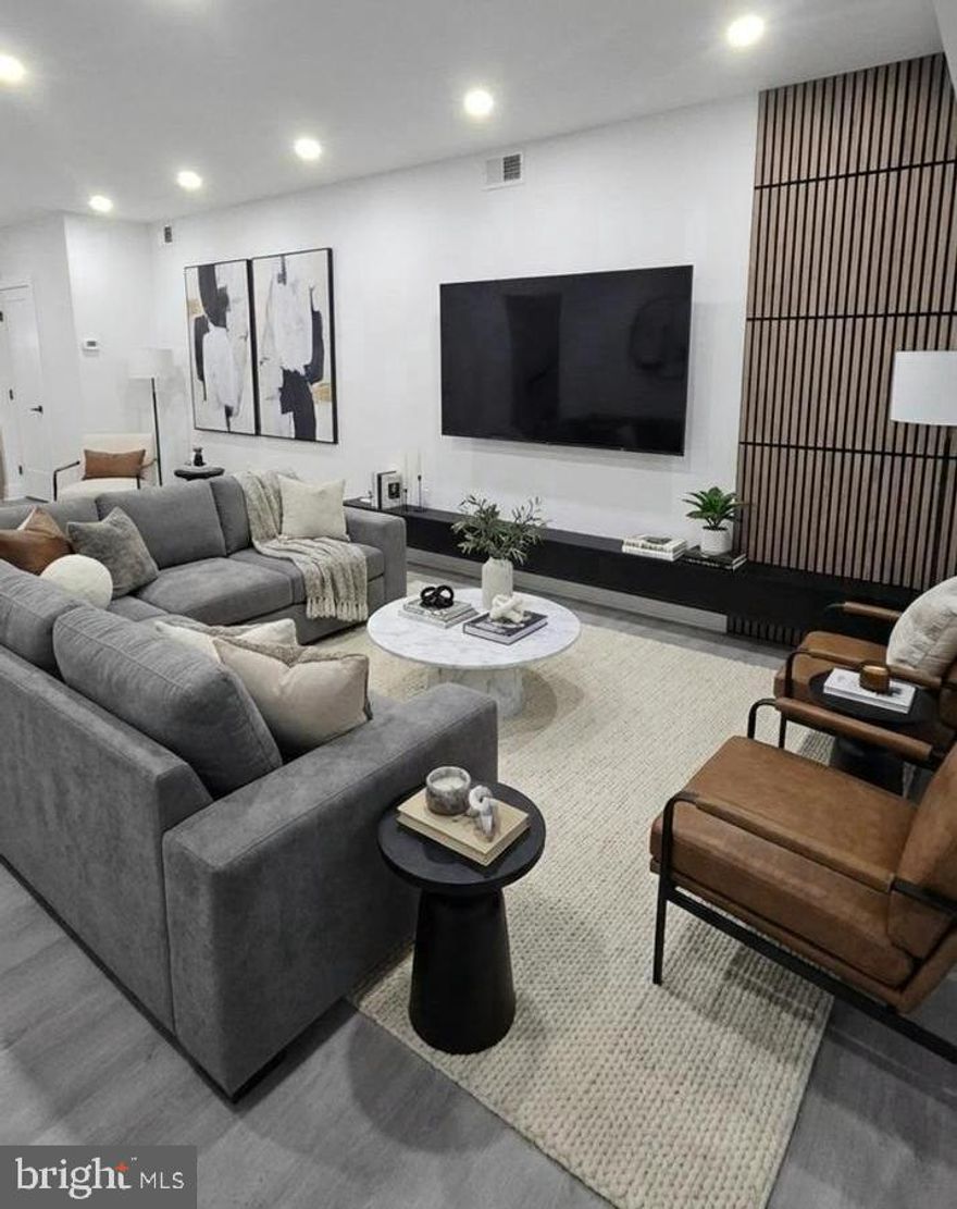 Step into this beautifully renovated 3BR / 2.5BA home offering modern living at its finest. Highlights include a fully finished basement, central A/C, and a stylish kitchen with wood-color cabinets and stainless steel appliances. The home features ultra-modern bathrooms, fresh updates throughout, and the added bonus of a park located directly across the street—perfect for relaxation and outdoor enjoyment. Plenty of street parking available. A true turnkey gem!  The property has been digitally staged to showcase it's potential.