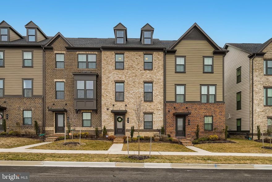 Life in the suburbs reimagined. Welcome home to Greenleigh at Crossroads, a modern urban village of luxury townhomes, neighborhood shops, pocket parks & amenities for an active lifestyle. Move up & live Greenleigh. This neighborhood is more than just a place to live. This neighborhood comes fully connected with community clubhouse, pool, fitness center with yoga studio, gardens, private dog parks, and walking/biking trails. You will fall in love with this 3 bedroom/ 3 bath attached rear-entry garage beauty. Walk into your main level, with family room that has potential to become a main level entry bedroom. You will also find a half bath, great for entertaining guest, and a den for those work from home days.  Come up to your gourmet kitchen with upgraded cabinetry, granite counter tops, huge center island, and all stainless steel appliances. Beautiful custom backsplash, double door pantry, and glass door hutch complete this area. Kitchen leads out onto your private, spacious deck,  perfect for entertaining all year around. Upper level includes your owners bedroom with a huge walk-in closet and en-suite with frame-less shower and soaker tub. All brand new carpet, less than a couple weeks old! Laundry room conveniently located on the upper level as well. No need to worry about storage space, generous closets abound in all bedrooms. Never fight for parking again, with your private two-car garage. Why wait for your home to be built, this house is available NOW! Make your appointment today, learn why Greenleigh was named Community of the Year by The Maryland Building Industry Association!