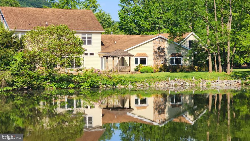 An unparalleled opportunity for lakefront living! Discover this inviting lakefront colonial, gracefully set on an expansive 1.49-acre level lot – a true rarity in desirable Carroll Valley. This spacious home with 3 bedrooms and 2.5 baths is designed for comfortable living.
Some of the features are the kitchen with a dedicated breakfast area, a separate dining room  for formal gatherings, an inviting living room, and a cozy den with charming pocket doors, offering flexible living spaces. A multi use room, perfect for an office,  provides the ideal work area.
Beyond the main living areas, you'll find an inviting sunroom, bathing in natural light, and a massive great room, complete with a warming gas fireplace – the perfect hub for creating cherished memories with loved ones. 
The exterior is an entertainer's dream, featuring a generous deck, a charming gazebo, and a picturesque circular driveway. Car enthusiasts and hobbyists will revel in the four large garages, two of which offer a substantial walk-up room with incredible potential for a studio, workshop, or additional living space. The vast, level lot is a gardener's paradise, offering endless possibilities for cultivating your dream landscape.
Nestled in the heart of Carroll Valley, you're just moments from the thrilling ski slopes of Liberty Mountain and two pristine 18-hole golf courses, offering year-round recreation. Not to be forgotten are the beautiful Adams County itself, with  gorgeous apple and peach orchards and the historic, memorable Gettysburg.
This isn't just a home; it's an inviting sanctuary where every day feels like a vacation. Don't miss this truly unique chance to embrace the lakefront lifestyle! 
Sellers have indicated that they will consider all reasonable offers.