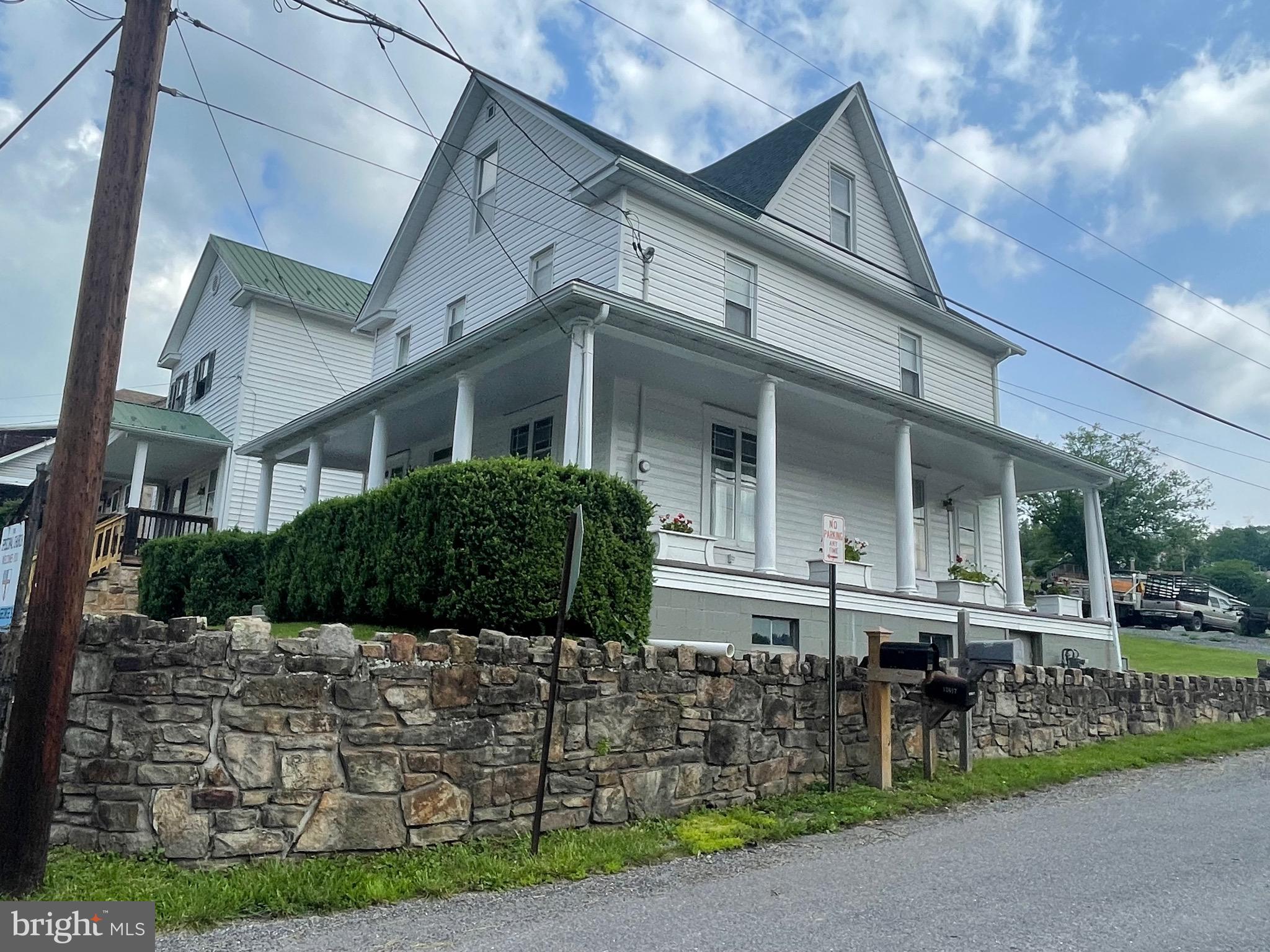 Imagine enjoying a cup of cold brew on the grand, wrap around porch, while watching the Western Maryland Steam Engine roll along the mountainside, all from your new well maintained home in the heart of Mount Savage. The main level features large living and dining spaces with high ceilings, kitchen with dishwasher and a well laid out laundry room and half bath. Stroll up the beautiful staircase to 4 bedrooms and a full bath. Don't forget to look all around for all the special character offered in this home, from original wooden stair rails to stained glass and even your own speakeasy in the basement! On street parking for now but yard offers plenty of room for a parking pad. Roof is 3 years old. Come see how much this home has been loved and cared for through the years!!!