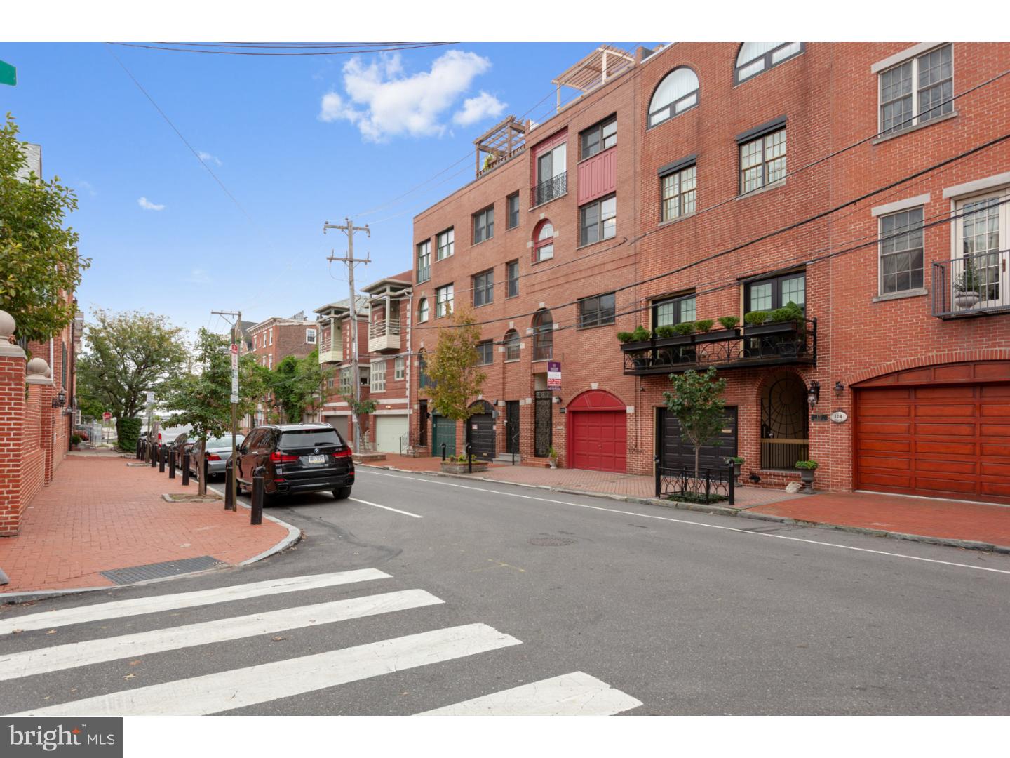 Come see this spectacular, open, light-filled 4200+ square foot home (including finished basement) with garage parking and a large roof deck with the "absolute best panoramic views of the city", located in the Meredith catchment in Queen Village. This meticulously remodeled 3 bedroom (plus a large den that can easily be converted to a 4th bedroom) 2.1 bath home features a dual zoned smart controlled HVAC system, 2 wood burning fireplace, distressed Red Oak hardwood floors, crown molding, custom designed closets, granite counter-tops, designer blinds, a maintenance free deck, a lovely stack stone patio, two wet bars, tons of storage, high ceilings and so much more! As you enter the home through the gated tiled alcove you will pass the exposed brick wall and a renovated powder room leading to a large and open family room with a brick fireplace and wet bar with granite counter-tops. Off of the family room is a beautiful stacked stone courtyard perfect for grilling and relaxing Up one flight of stairs is the eat in kitchen with tiled backsplash, ceramic tile floors and Eco counters by Cosentino. Off of the kitchen is a large living room with a stone wood burning fireplace, a nice sized dining room and a 12 foot sliding glass door to let in plenty of light. On the 3rd floor are two large bedrooms (one is presently being used as an art studio), a large laundry room and a full upgraded bathroom with soaking tub. One more flight up leads to the master bedroom with a wood burning fireplace plus a large den that can easily be converted to a 4th bedroom. The upgraded 4th floor master bath features tile flooring with radiant heat and a large walk-in rain shower. One more flight up leads to the large roof deck with a panoramic view of the City (both bridges and the City skyline!). Finally, there is the finished basement with Core-tec flooring and plenty of extra storage space. This home is centrally located within walking distance to the Italian Market, the Head House Square Farmer's Market & many great restaurants & shops. Come make this fantastic home yours & see why Queen Village is one of the City's most sought after neighborhoods. Beautiful unique accents throughout the home are a must see! Please ask your agent for a complete list of features & upgrades as this home has too many to list here.