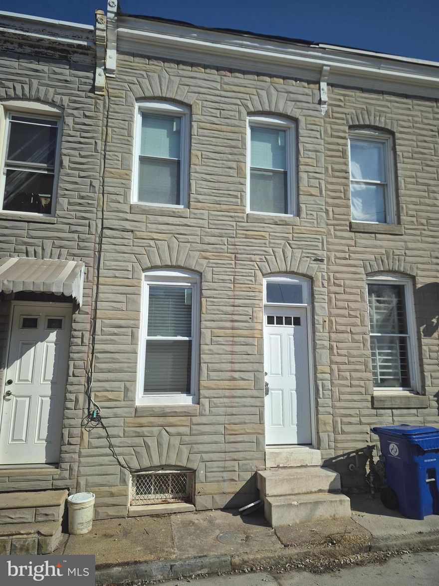 Great investment opportunity in Baltimore's Middle East neighborhood near Johns Hopkins Hospital. This turnkey 2-bedroom, 1.5-bath townhome features new flooring, drywall, paint, exposed brick, forced air heat, a 2017 water heater, and wood-style floors throughout. The main level offers living, dining, and kitchen spaces; the upper level includes two bedrooms and a full bath. The basement has open space, utilities, and a half bath. The property also boasts an enclosed patio and backyard. No off-street parking; alley access only.