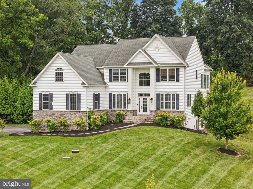 Perched high on over 1.5 acres of lush, usable land with panoramic views, this impeccably designed and decorated 5-bedroom, 2.5-bath showpiece delivers elevated living inside and out. With its commanding hilltop presence and sleek interiors, this home is located in a coveted pocket of West Chester, yet within the bounds of the award winning Downingtown Area School District.
Step inside to an open, sun-soaked floor plan anchored by rich hardwood floors and a dramatic two-story family room with soaring windows that capture the landscape like art. Extensive custom molding adds a refined touch to both the formal living room, dining room and family room, creating spaces that are as elegant as they are comfortable. The formal living room has been turned into what feels like a stylish hotel bar and offers bold floor to ceiling millwork and plantain shutters.
The chef's kitchen is as functional as it is fabulous, featuring a built-in Sub-Zero refrigerator, separate gas cooktop, double oven, leathered granite countertops and a bright breakfast room—made for gathering and grazing. When entering from the three-car garage, you'll notice the soaring 15+ foot ceilings that offers exceptional space for boats, car lifts, or a custom mezzanine level. Enter the home, and the drop zone area offers the perfect space for backpacks, shoes and helps to keep the home clutter-free. And just adjacent, the tucked-in main floor 5th bedroom is currently used as an office and lounge space, quietly tucked away from the rest of the open entertaining areas.
Upstairs, the primary suite is accessed via the cat walk between the guest bed and full bath. It offers a private retreat with sweeping views and a personal balcony that overlooks preserved farmland where horses roam—a truly magical backdrop for your morning coffee. The suite includes an adjoining bath with dual vanities, corner soaking tub, and a large glass stall shower with two shower heads. The suite goes on to include dual closets, one of which is outfitted with a custom built-in system and dressing table. An additional bonus space within the suite is currently used as a home gym, offering flexibility and function.
The unfinished daylight walkout basement is a blank canvas with smart upgrades already in place, ready to become whatever your lifestyle demands—think gym, theater, wine cellar, or all of the above.
Curb appeal is next-level, with slate and stone steps leading to the front entrance, lighted trees and pillars lining the driveway, and raised garage doors that open straight up—both sleek and functional. The flat backyard is fenced with attractive black aluminum fencing and tall evergreens for added privacy and frames a stunning outdoor entertainment area complete with a newly built pergola, fireplace, and lounge space perfect for al fresco evenings.
This home delivers the best of both worlds—peaceful, private countryside living with convenient access to the vibrant heart of West Chester, Marshallton, Downingtown, top schools, and commuter routes.
Modern luxury meets natural beauty. Welcome home.