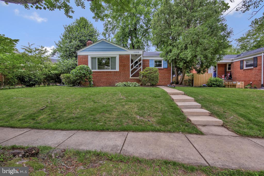Charming, Fully Updated Brick Home in Prime North Kensington Location! Welcome to this beautifully updated two-level all-brick home offering stylish living space in the heart of North Kensington. With 2 spacious bedrooms (and 2 dens in the lower level), 2 full baths, and a flexible layout that feels both modern and warm, this move-in-ready home truly has it all. Step inside to an open, light-filled floor plan featuring gleaming floors, recessed lighting, and a large living area centered around a cozy wood-burning fireplace with a striking white brick surround and custom mantel. The gourmet kitchen is a showstopper—complete with an island, breakfast bar with pendent lighting, granite countertops, subway tile backsplash, stainless steel appliances including a gas range, and crisp white cabinetry accented with sleek nickel hardware. Off the kitchen is the dining area, creating the perfect space for everyday meals or entertaining guests. From the dining area, sliding glass doors lead to a deck and fully fenced backyard—ideal for summer barbecues, gardening, or play. The main level also offers two generously sized bedrooms with ceiling fans and a luxurious hall bath with a double-sink vanity and tub/shower combo. Downstairs, the fully finished lower level provides even more living space with a large recreation room and two additional rooms with closets—perfect for a den, home office, gym, or playroom. This level also includes a laundry area with washer and dryer, as well as a chic full bath featuring a modern tiled shower. Location, location, location! Enjoy all the charm of walkable Kensington—just minutes to the shops and restaurants of historic Old Town, BabyCat Brewery, Noyes Children’s Library, and more. Commuters will love the easy access to the MARC Train, Wheaton Metro, Ride-On bus, and major routes like I-495 and I-270. You’re also close to Rock Creek Park, Beach Drive, and popular parks including Newport Mill and Kensington Heights. With its blend of space, style, and unbeatable convenience, this home checks every box. Schedule your private tour today—homes like this don’t come around often!