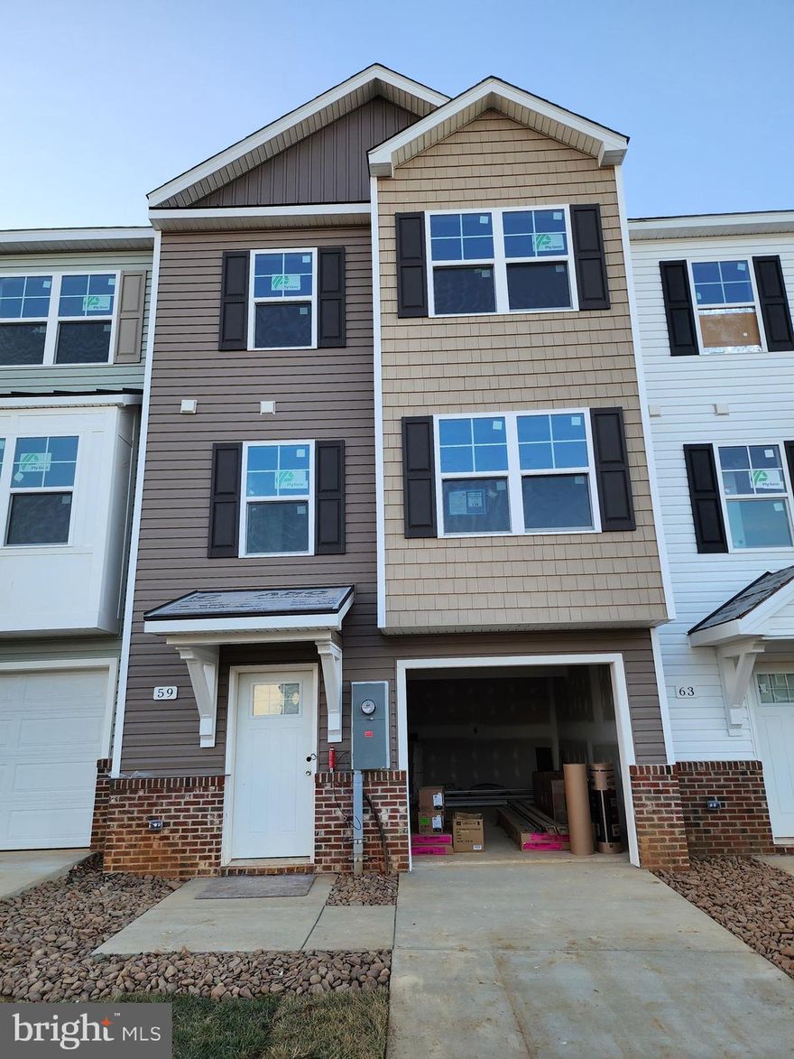 Quick Delivery!!!! The Berkeley II Garage townhome. 
YOUR FIRST YEARS POWER BILL IS ON US!!!! Up to 3% of closing cost assistance!!!
This 4 bedroom, 3.5 bath garage townhome has an open concept design on the main floor w/ a kitchen island with granite top, 42" maple slate cabinets, a high low peninsula with granite top for entertaining, stainless-steel appliances, a large living room w/ a bump out and a half bath. The upper level features a large primary bedroom w/ cathedral ceiling, walk-in closet, double vanity and a walk-in tile shower; two guest bedrooms, one of which has a 2-story bump out, full guest bathroom, linen closet and laundry. The lower levels feature a coat closet, foyer, single car garage w/ automatic garage door opener (app enabled also) and fourth bedroom with a full bath w/ door to access to your backyard, this room makes a great recreation room as well. There will be NO homes built behind you here!!! Throughout the home you will find recessed LED's, ceiling fans in the Primary bedroom & living room w/ each additional bedroom pre-wired for ceiling fans. High/Low outlets w/ pass through plates w/ CAT5/COAX/HDMI in Owner's bedroom & living room to make mounting your TV a breeze, interior fire sprinklers and a water softener. You get more for your money with Four Points Construction. We are a featured loaded builder.  Winner of WV Best in Class for Energy Efficiency - The Communities of Burwell has done it again! Pictures are of similar construction townhome.