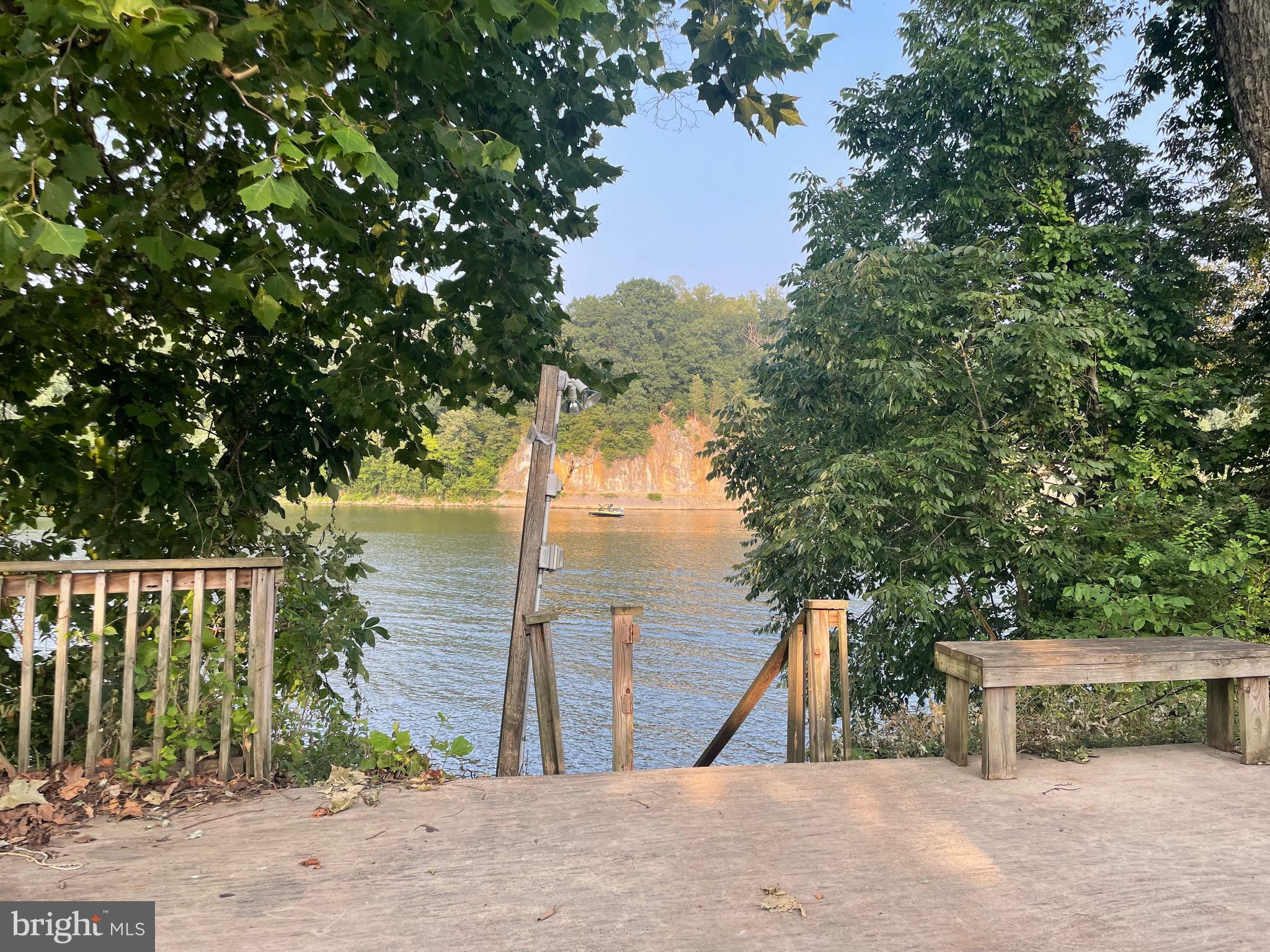 Welcome to your perfect getaway on the river! This stunning riverfront lot offers 41 feet of direct water frontage and your very own private dock, making it ideal for boating, kayaking, fishing, or simply soaking in the scenic views. With a spacious concrete patio and deck, you’ll enjoy unbeatable sunsets and riverside relaxation all season long. Included on the lot is a well-maintained 2018 camper, offering all the comforts of home, plus a shed with electricity—perfect for storing gear or converting into a cozy hangout space. There’s ample parking for guests, and plenty of space to entertain or unwind. Located within a park community, you’ll have access to top-notch amenities including multiple pools, mini golf, an on-site restaurant, camp store, and more. Whether you're seeking a peaceful weekend retreat or an action-packed family getaway, this lot has it all. Don’t miss this rare opportunity to own a slice of riverfront heaven – bring your water toys and start making memories today!
To view the property - Riverbend Park is a gated community you need to enter at the guard shack. Entry is not permitted without ID per the office rules. Bring IDs to the office or guard shack for visitor pass. THIS IS A SEASONAL CAMPGROUND -OPEN FROM APRIL 1 TO NOVEMBER 1. River Bend is a privately owned 400 acres recreational- vehicle camp resort with seasonal activities for members, families and guests. This great RV park is tucked away on the Upper Potomac River of West Virginia; Riverbend is one of West Virginia's most popular family seasonal destinations. Just a short drive from the Washington and Baltimore metro area. Open with utilities from April 1 to November 1. (Lot owners have access to their property during the off season). Riverbend Park offers lots of fun and entertainment, or a great place to get away and relax. 10 miles of Deep water on the Potomac River, access for boating, fishing & swimming and other park amenities include 3 swimming pools, putt putt course, Horseshoe club, Boat club, Poker runs, Trick or Treat, Christmas in July, live bands, basketball court, tennis court, fireworks, car show, Church, restaurant, bar, convenience store, playground, volleyball, ball field and much more.