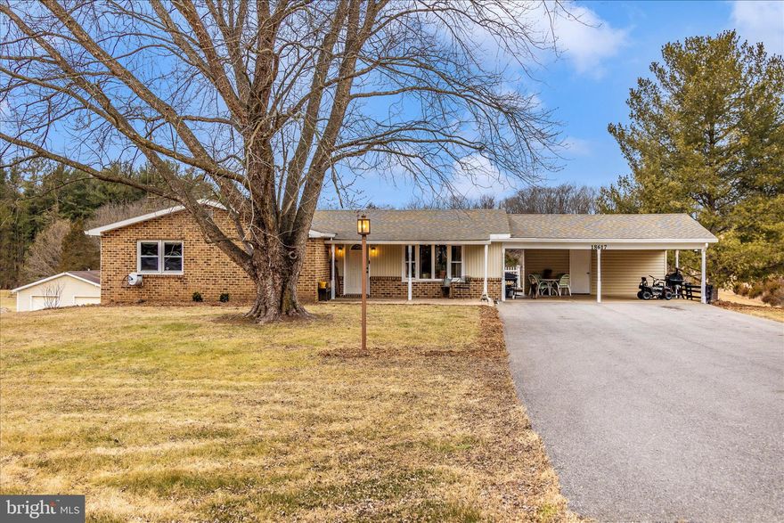 Private, peaceful, and move-in-ready, this rancher sits on over 3 acres with wooded views beyond the property line and beautiful sunset views from the expansive rear deck. The major systems and components have already been updated.  
The main level offers three bedrooms and two full bathrooms, including primary bedroom with ensuite and a generously sized second bedroom.  The fully finished, walk-out basement includes a kitchenette and provides excellent flexibility for guests, multi-generational living, or extended living space, with the potential to easily add an additional bedroom and bathroom. 
Some of the recent improvements include a new HVAC system with professionally cleaned ductwork, moisture barrier and insulated crawlspace, updated electrical panels, refinished hardwood floors throughout the main level, and underground electric dog fence.  
An attached two-car covered carport with additional storage provides everyday convenience, while an oversized detached garage with electric adds exceptional value -- ideal for vehicles, a workshop, or storage space.  The garage features a 45,000 BTU heater, window a/c unit that conveys, and measures 40'x30'.
There's no need to wait or overthink this one--schedule your tour, move right in , settle in comfortably, and look forward to an abundant summer blueberry harvest from your own mature blueberry bushes.