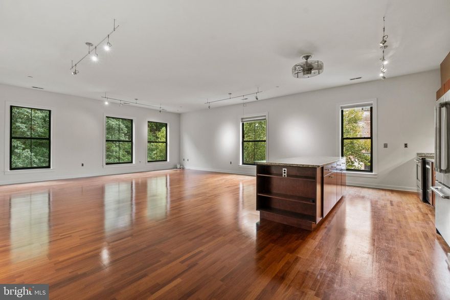 Impressive corner unit at the Mill Race Condominium for sale. Windows wrap the apartment on three sides offering views of Druid Hill Park, the Clipper Mill pool, and the studio buildings.  Measuring over 1600 square feet and featuring hardwood floors, tall ceilings,  and good closets.  Large kitchen perfect for entertaining. Loft-style layout with no upstairs neighbor, it's a corner penthouse.  This location has a lot to offer including award winning restaurants, fitness studios, and artist studios. A close proximity to the Woodberry Light Rail Station. Condo fee includes 1 garage parking space.   Access to acclaimed community pool available in summer months. This is a pet friendly building.  Equal housing opportunity.