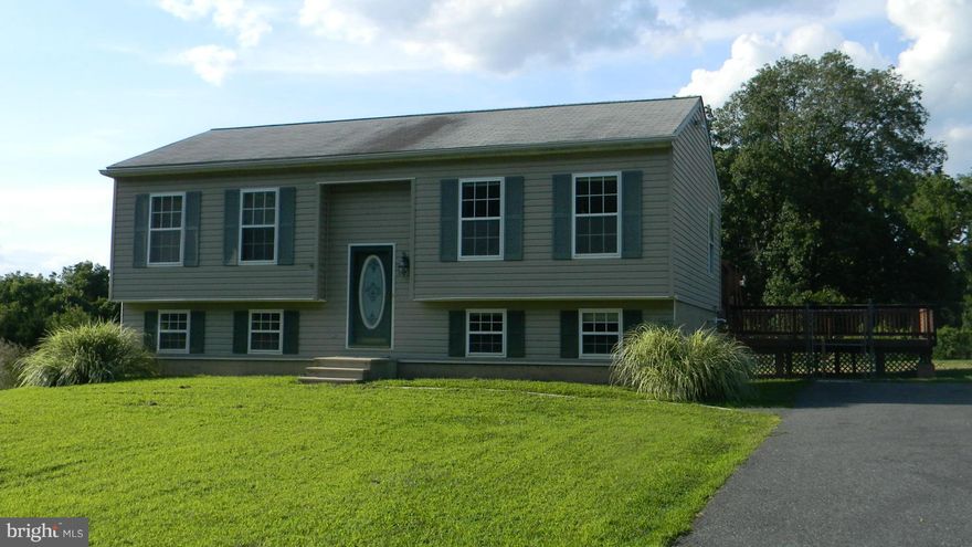 Fresh paint and carpet throughout.  Kitchen sliders to large, two level deck.  Laminate flooring in living room, hall and second BR, lower level large family room with sliders to patio.  Propane heat and baseboard electric.