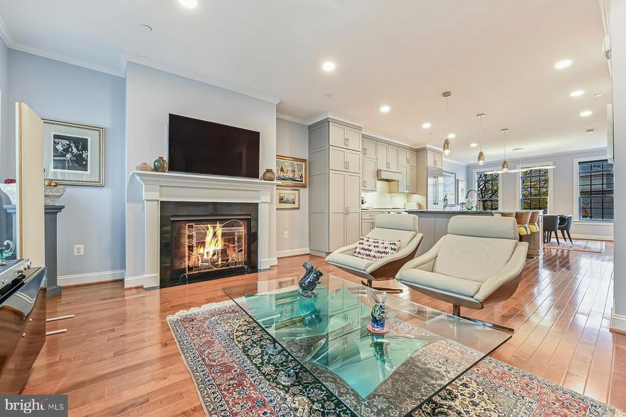 285 West Street #2 offers an incredible opportunity to enjoy the downtown Annapolis lifestyle in a newly constructed, low-maintenance town home with an elevator! This 4-bedroom, 4.5-bathroom Bozzuto-built residence has an exceptional blend of modern luxury and timeless charm. Built in 2020, the owners have invested a tremendous amount into further upgrades to create a true jewel box: refined new flooring, custom lighting, and designer fixtures elevate every room. 
One of the rare assets of the location is a two-car garage. It is a level entry into the ground floor level that includes a bedroom (currently used as a den), full bath, and elevator access. How easy to bring up the groceries or bring suitcases down for a vacation! The main level, one floor up, is the great room and includes a lovely seating area, gourmet kitchen, and spacious dining area. Family and guests can chat with the chef or enjoy the ambiance of the gas fireplace. The kitchen, a true work of art, is outfitted with a rare Blue Bahia granite island countertop, top-of-the-line appliances, and beautiful pendant fixtures. New hardwood floors encompass the entire space, and the dining area offers a built-in sideboard with beverage center and glass-front cabinets. The open concept is perfect for entertaining or having a small-setting, cozy evening. There also is a powder room on this level with custom finishes. 
The next level up is the primary bedroom suite with a spa-like bathroom and two walk-in closets. The ceramic tile shower has multiple shower heads and a built-in bench, and there is a separate soaking tub. There are two vanities and a water closet. The laundry is on this level as well. The fourth floor has two additional bedrooms, each with hardwood floors and its own bathroom. The top level will be the envy of all your friends – a roof-top deck, accessible by elevator, offers views across Annapolis. The approximately 600 SF deck has a fireplace, sunshade, and is equipped with water and refrigeration for easy entertaining.
The entire unit flows effortlessly, with generous proportions and an airy, light-filled atmosphere. Perfectly poised between the energy of downtown and the calm of a private retreat, this home invites you to experience Annapolis in a way few can.